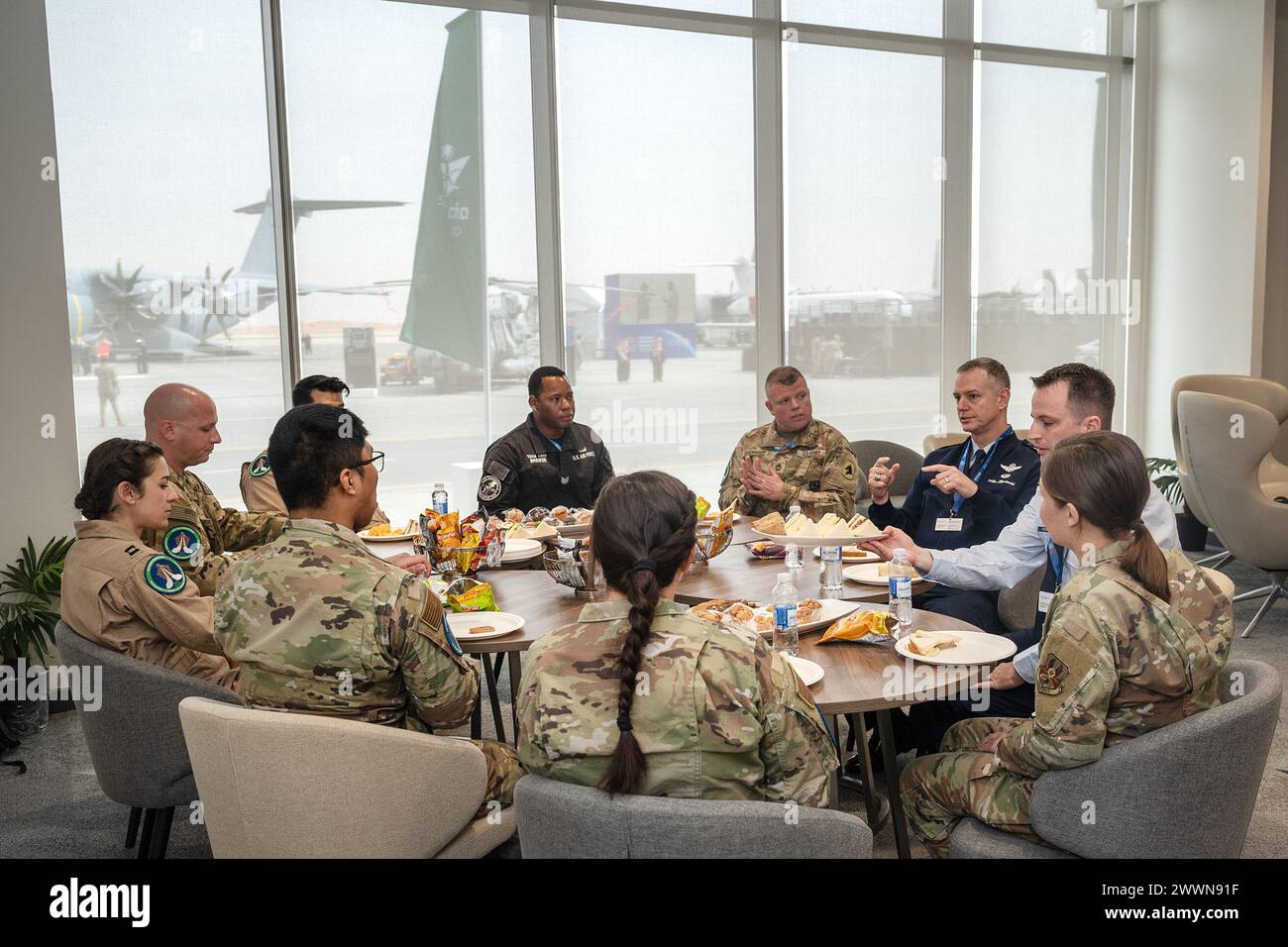 U.S. Air Force Lt. Gen. Alex Grynkewich, top right, U.S. Air Forces Central and Combined Forces Air Component Commander, speaks with service members during a lunch at the Saudi World Defense Show near Riyadh, Saudi Arabia, Feb. 5, 2024. Grynkewich highlighted the importance of relationships with partner nations, along with how those connections increase regional security and deter adversaries. The U.S.’s commitment of personnel and aircraft to the Saudi World Defense Show highlights the importance of continued defense cooperation between allies and partners with a shared vision for enduring pe Stock Photo