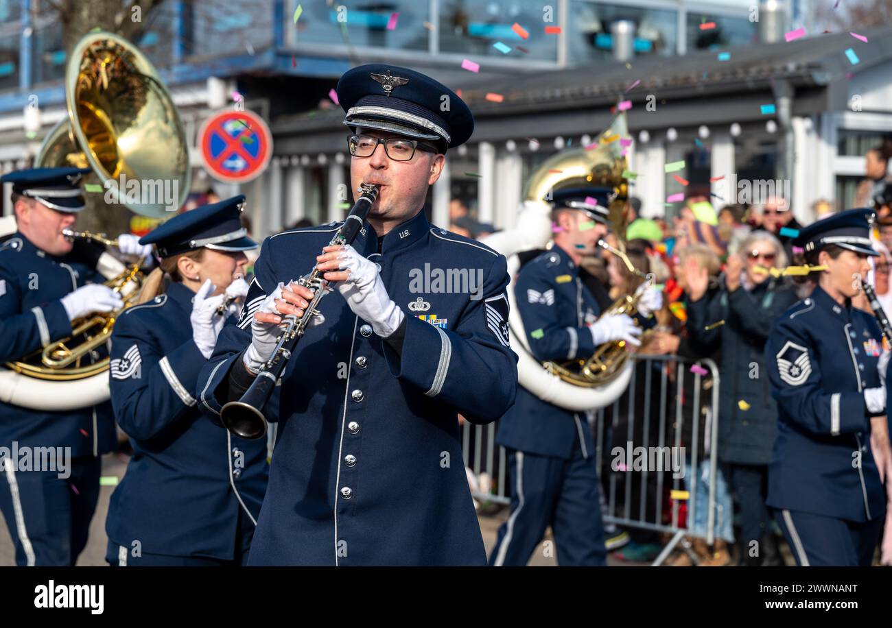 The U.S. Air Forces in Europe and Air Forces Africa (USAFE-AFAFRICA) Band march in the 73rd Annual Ramstein Fasching Parade, in Ramstein-Miesenbach, Germany, Feb. 13, 2024. Approximately 13,000 people lined the streets, many in costumes, with over 90 performance groups and associations consisting of 1,400 participants who marched or drove in the parade to entertain the crowd.  Air Force Stock Photo