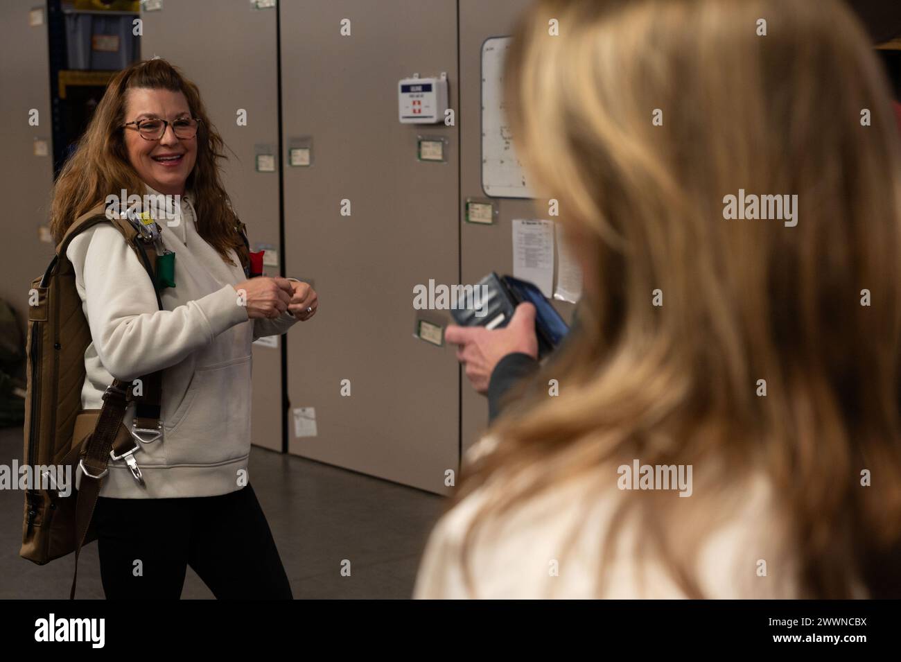 Judy Schlott, 436th Medical Group honorary commander, tries on a