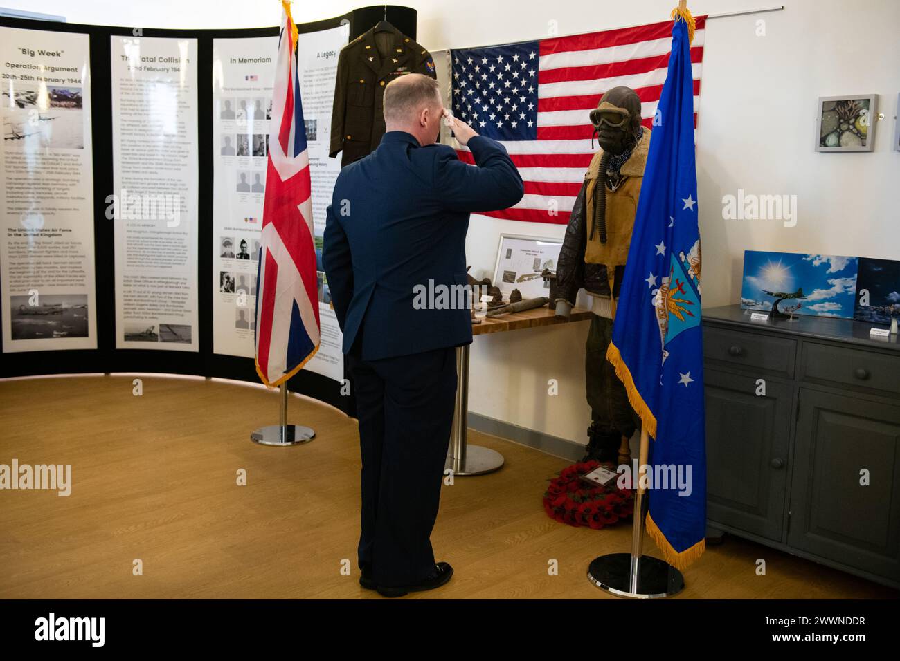 U.S. Air Force Col. D. Landon Phillips, 501st Combat Support Wing commander, salutes while taps is played during wreath laying at a Ceremony of Remembrance at Stanwick Lakes, England, Feb. 22, 2024. U.S. and U.K. leaders gathered to honor 17 Airmen who died in a midair collision on Feb. 22, 1944, involving B-17 Flying Fortresses from the 303rd Bombardment Group at RAF Molesworth and the 384th Bombardment Group at RAF Grafton Underwood. The Airmen were part of Operation Argument, or 'The Big Week,' targeting enemy industrial sites and aircraft facilities in Central Europe to secure Allied air s Stock Photo