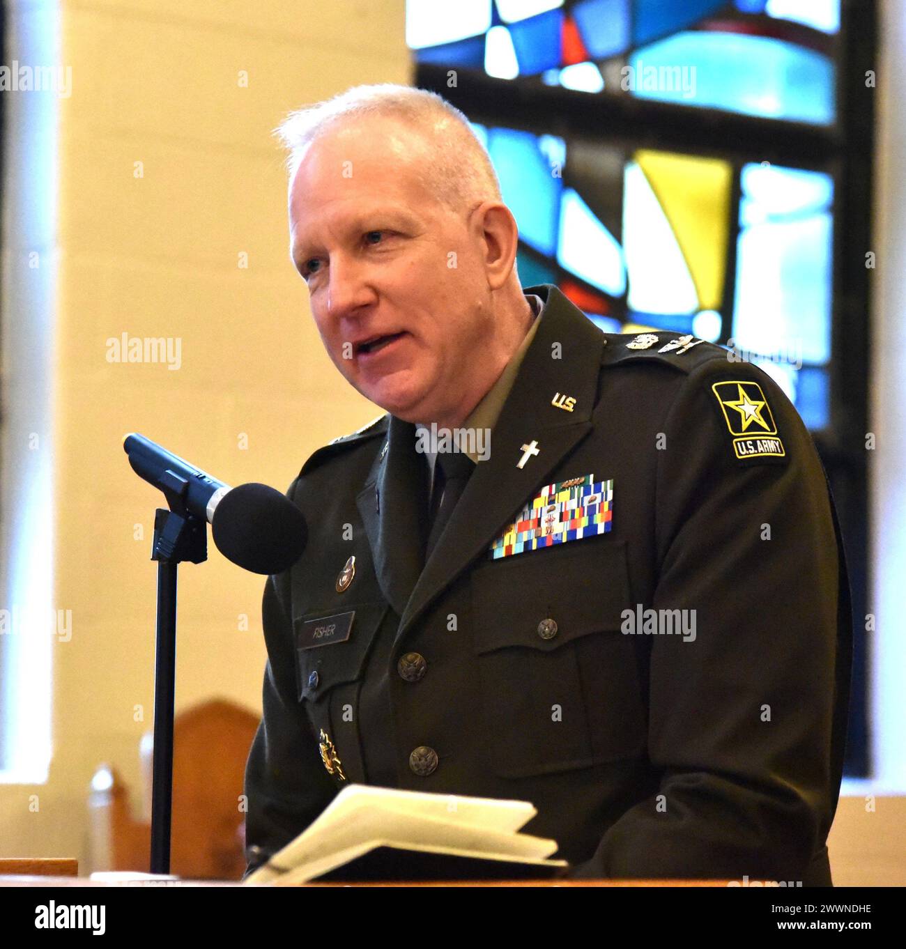 Chaplain Col. James F. Fisher addresses friends and family at his ...