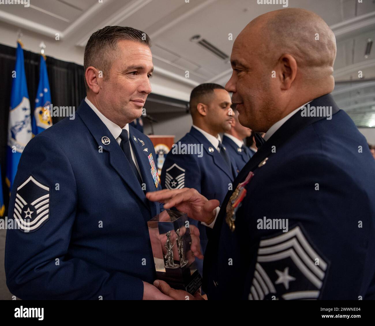 Master Sgt. Charles Wilding (left), the Kentucky Air National Guard’s 2023 Senior Non-Commissioned Officer of the year, receives the Kentucky Enlisted Exceptional Performance Award from Chief Master Sgt. Steven Best, 123rd Airlift Wing command chief master sergeant, during the Airman’s Gala at the Crowne Plaza Louisville Airport Exposition Center in Louisville, Ky., Feb. 10, 2024. The Gala celebrated the unit’s top-performing Airmen for 2023.  Air National Guard Stock Photo