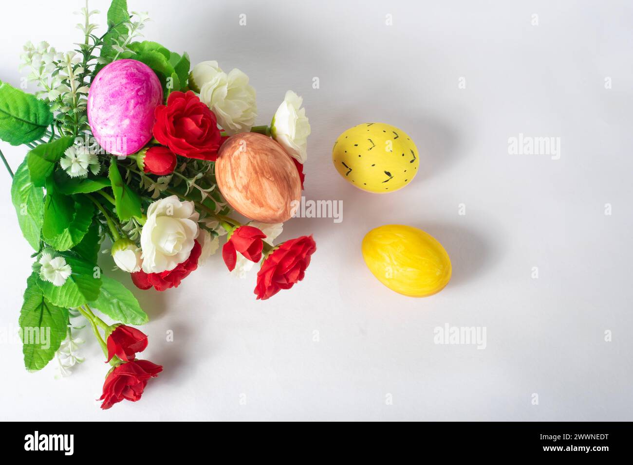 Spring Background Roses Easter Easter eggs and spring rose flowers on white background. Happy Easter ...