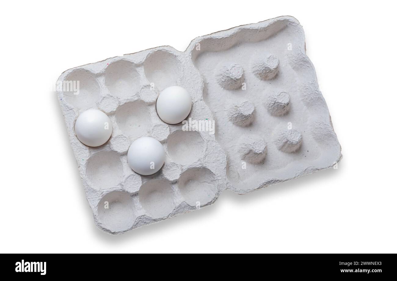 White eggs in a carton box on white background. Top view. Stock Photo