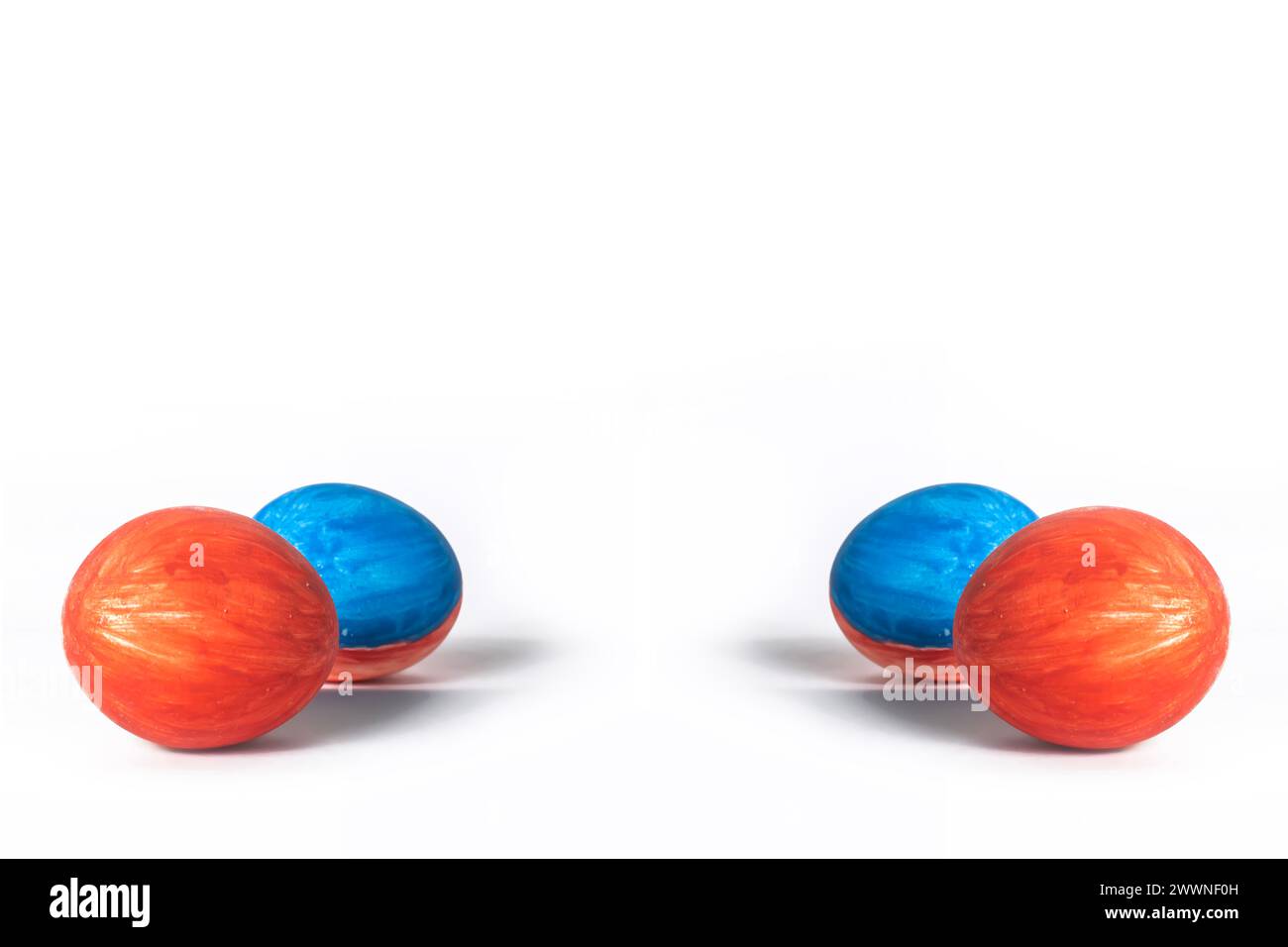 Red and blue painted easter eggs isolated on white background with copy space. Easter concept. Stock Photo