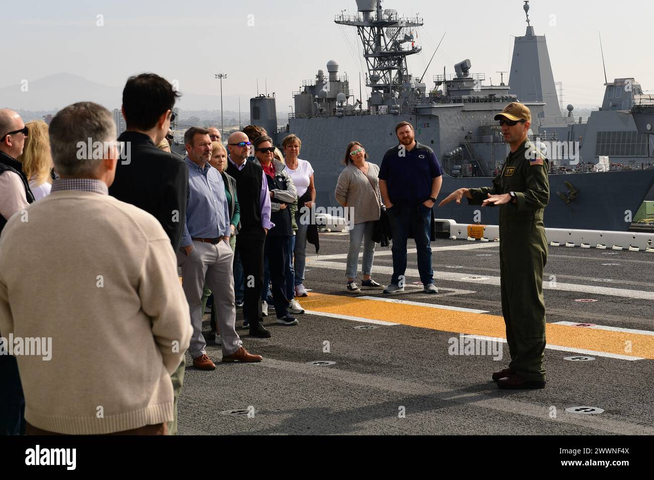 Cmdr. Michael Felber, USS Boxer (LHD 4) Air Boss, provides information about flight deck operations to superintendents from Pennsylvania schools during a tour of the ship, February 16, 2024. Boxer is a Wasp-class amphibious assault ship homeported in San Diego. ( Stock Photo
