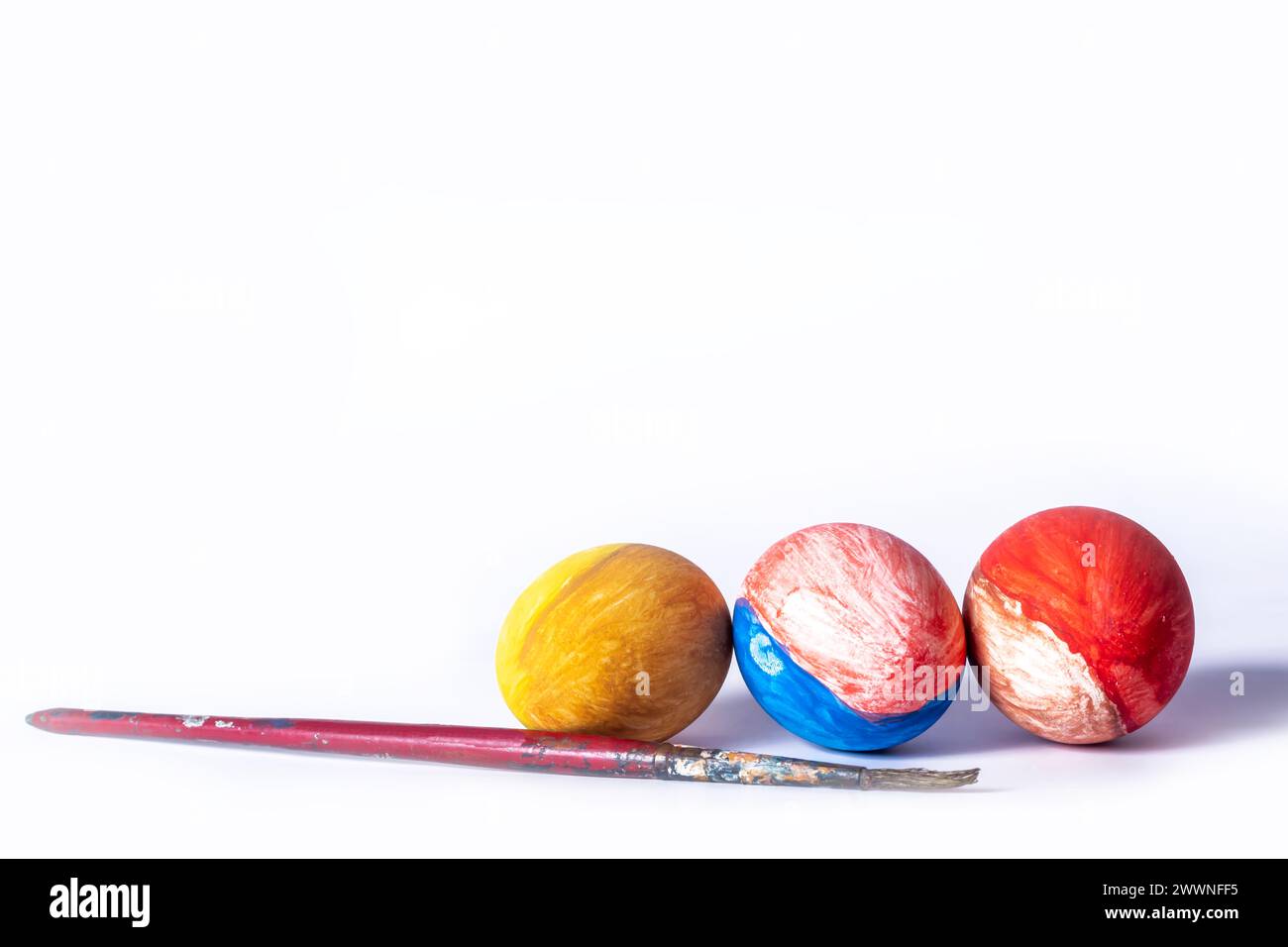 Colorful painted Easter eggs and paint brush on white background Stock Photo