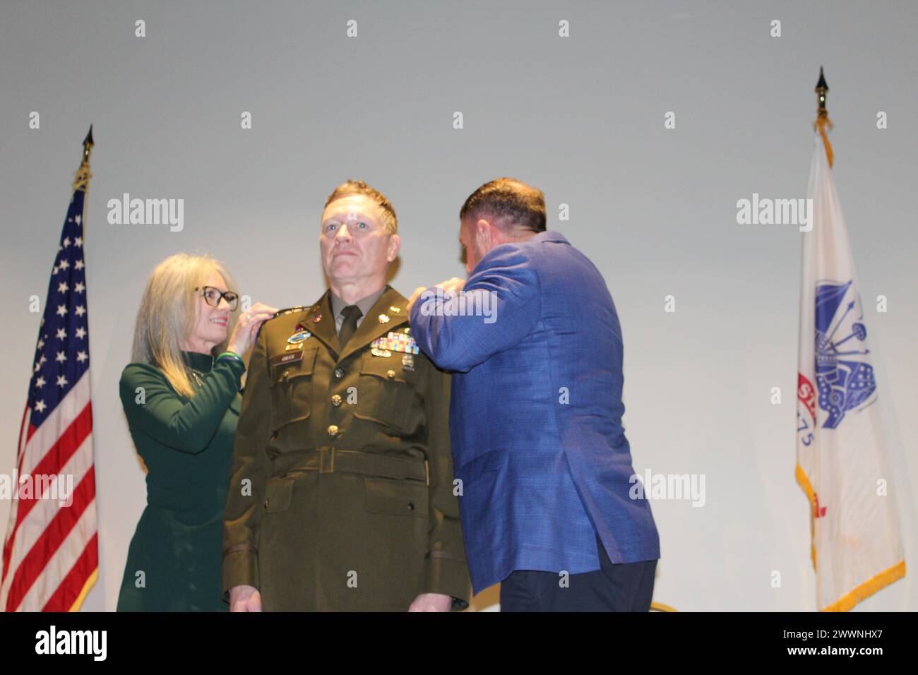 Warrant Officer 1 Craig Morgan Greer receives his new rank insignia from his wife, Karen, and John Clement, state field director and military adviser to U.S. Sen. Marsha Blackburn of Tennessee. Stock Photo