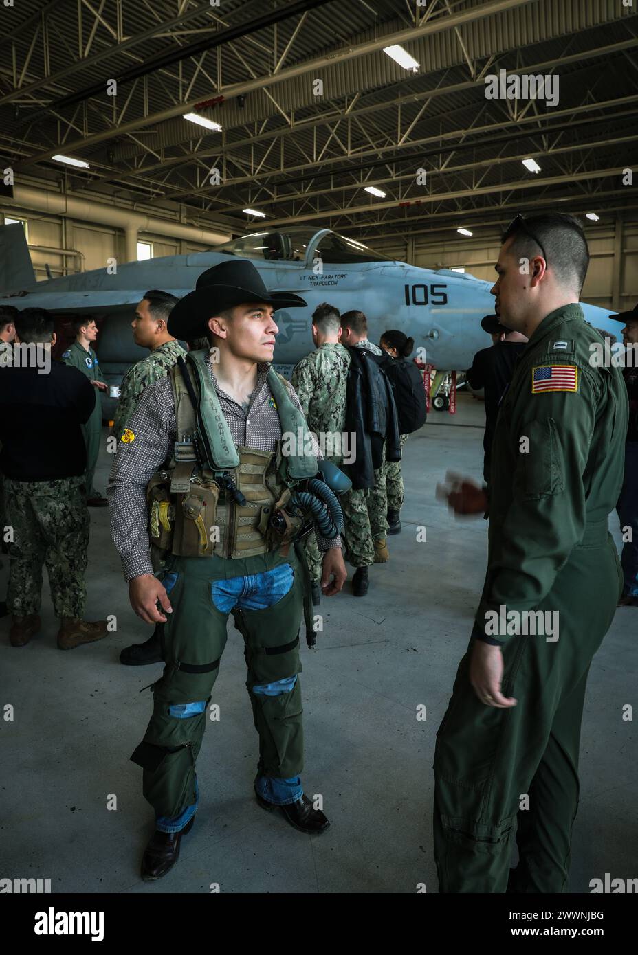 VIRGINIA BEACH, Va. (FEB. 23, 2024)- Professional Bull Riders (PBR) Andrew Alvidrez speaks to Strike Fighter Squadron (VFA) 37 “Ragin’ Bulls” pilots about their F/A-18E Super Hornets and the protective gear required to fly the aircraft. The Ragin’ Bulls returned Jan. 16 from an eight-month deployment supporting partners and allies in the U.S. Navy 6th Fleet area of operations aboard USS Gerald R. Ford (CVN 78).  Navy Stock Photo