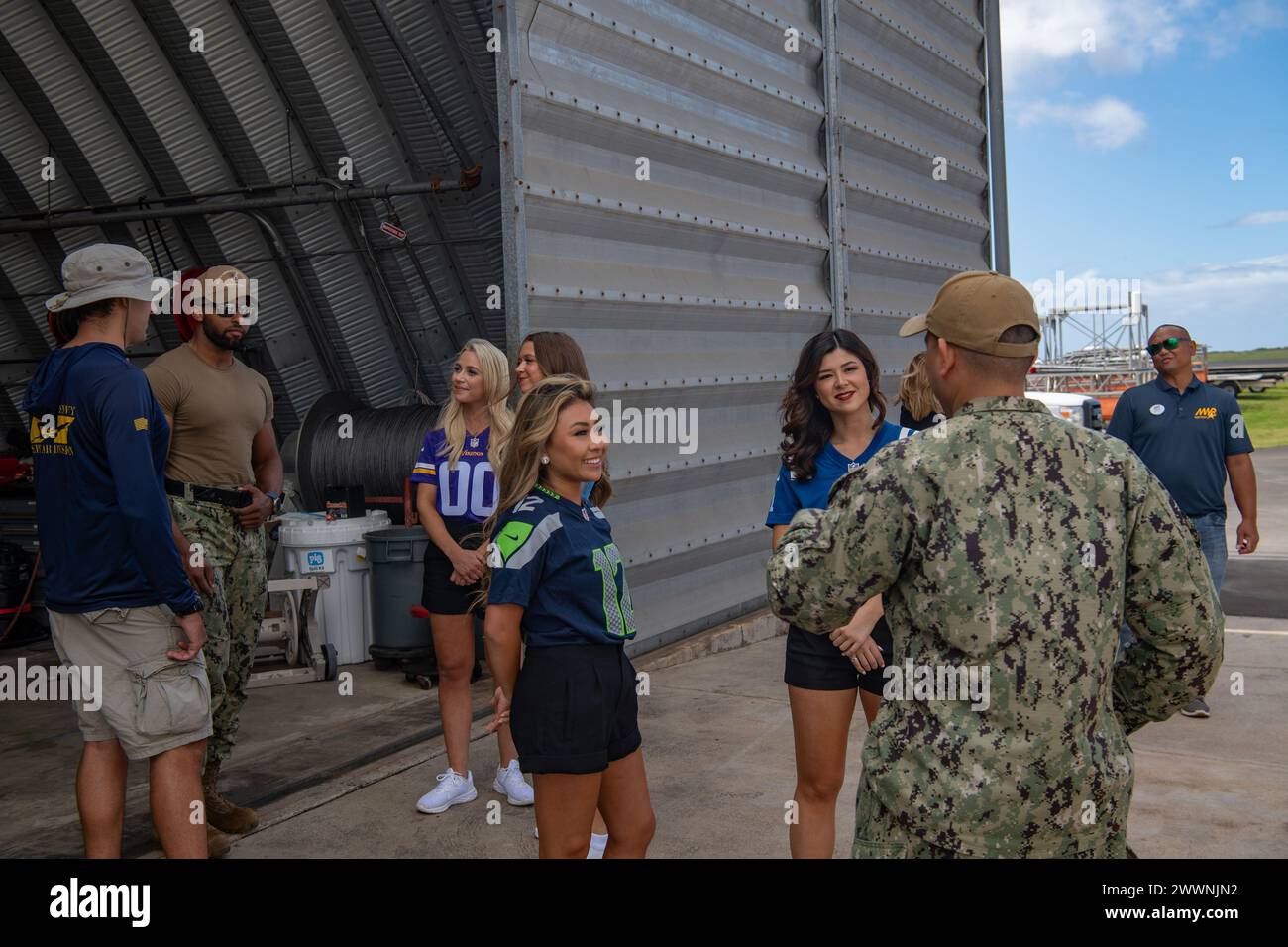 KEKAHA, Hawaii (Feb. 5, 2024) National Football League cheerleaders Whitney of the Minnesota Vikings; Hannah of the Indianapolis Colts; Kiana of the Seattle Seahawks; and Kayley of the Tennessee Titans talk to Sailors from SEPTAR as part of the Armed Forces Entertainment Pro Blitz Tour 24 on Pacific Missile Range Facilities, Barking Sands, Kekaha, Hawaii. Armed Forces Entertainment provides performances for U.S. troops and family members stationed overseas; over the last 70 years, AFE has served as a morale booster for U.S. troops on military bases around the world, the Department of Defense h Stock Photo