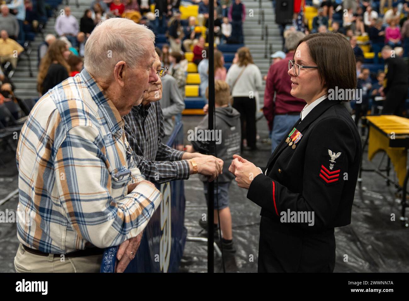240214-N-PN185-1009 – Soddy-Daisy, Tennessee (Feb. 14, 2024) - Musician 1st Class Sarah Demy, from Burke, Virginia, speaks with an audience member during intermission at the United States Navy Band performance in the Soddy-Daisy High School Gymnasium as part of the unit’s 2024 national tour.  The Navy Band will travel 2500 ground miles over 18 days to 7 states, giving 12 public concerts as well as 5 concerts for students in schools.  Navy Stock Photo