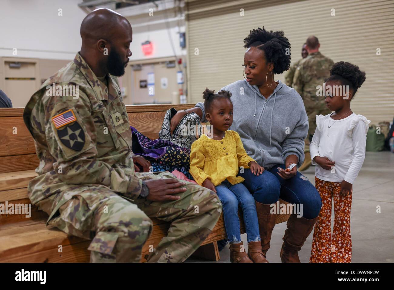 U.S. Army Staff Sgt. Idiaman Melvin, assigned to 8th Ordnance Company, 264th Combat Sustainment Support Battalion, 3rd Expeditionary Sustainment Command, spends time with his family before a guidon casing ceremony at Fort Liberty, N.C., Feb. 27, 2024. Melvin is part of a group of ordnance Soldiers rotating to Europe to support partners and allies.  Army Stock Photo