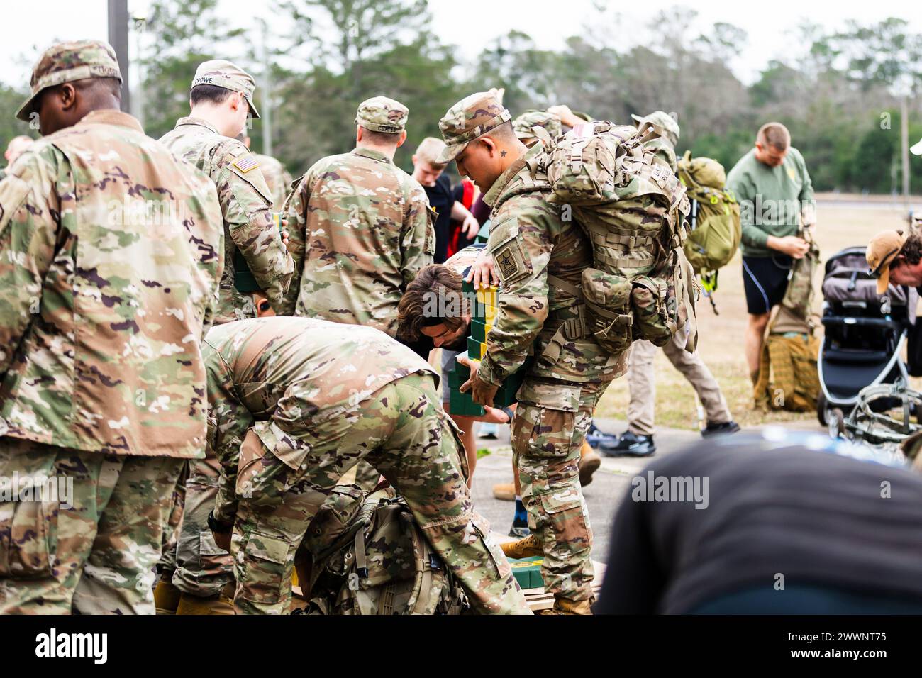 Warrant Officer Candidates volunteer to load bricks into ruck sacks for
