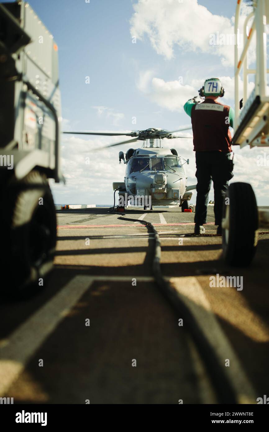 An MH-60S Seahawk Helicopter attached to Helicopter Sea Combat Squadron (HSC-5) prepares for takeoff on Nimitz-class aircraft carrier USS George Washington (CVN 73) in the Atlantic Ocean Feb. 13, 2024. George Washington is underway in support of future operations.  Navy Stock Photo