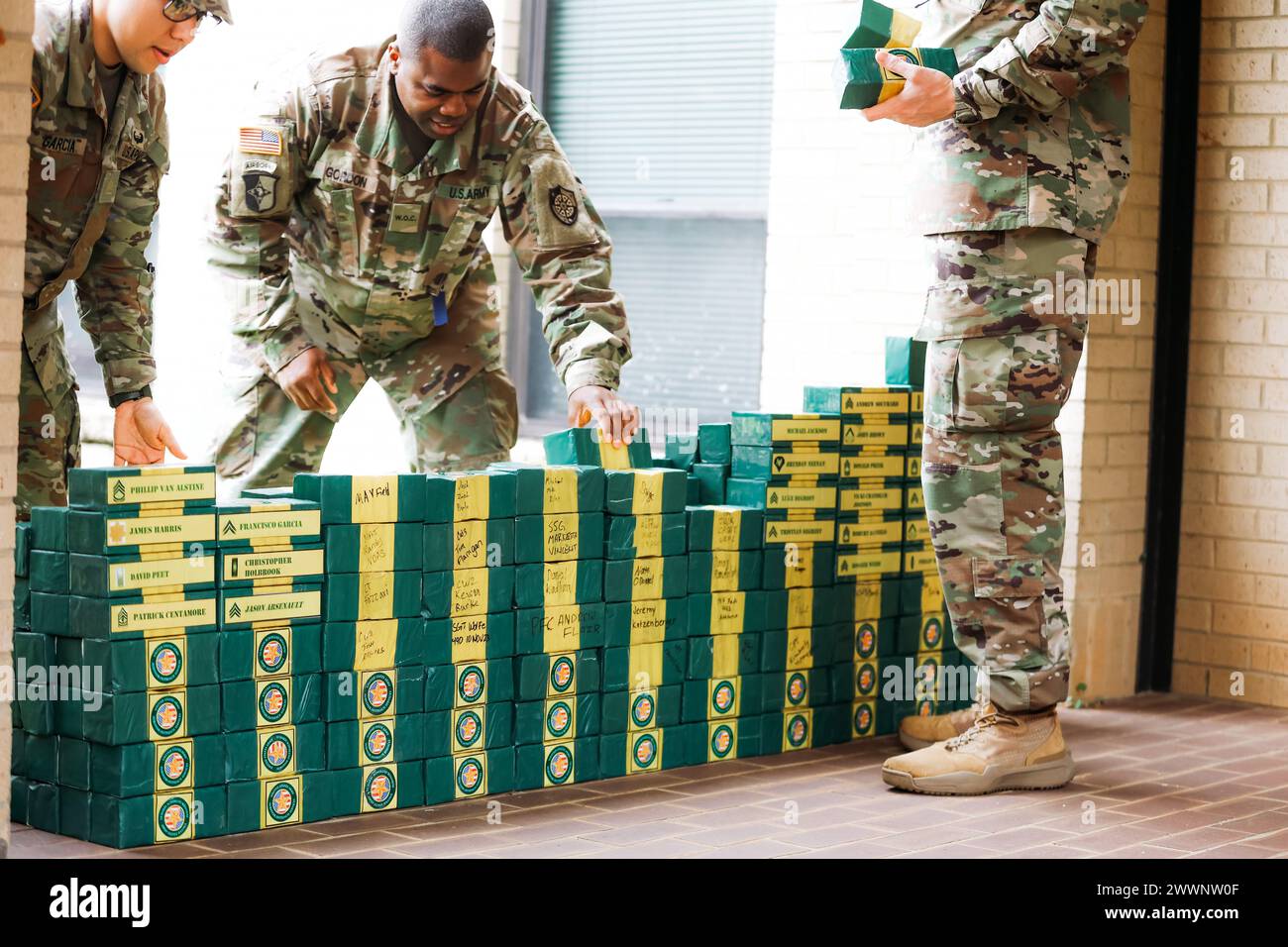 Volunteers help stack bricks at the finish line of Ruck to Remember on