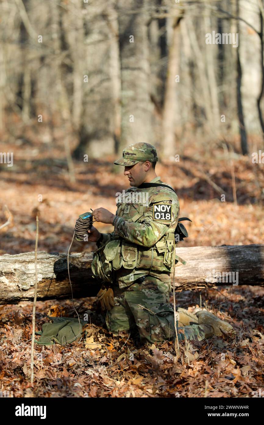 Tennessee Army National Guardsman Staff Sgt. Daniel Vasquez, from the 30th Troop Command, retrieves a practice claymore during the Tennessee State Best Warrior Competition in Tullahoma, Feb. 23, 2024. The claymore is a command-detonated fragmentation weapon designed primarily for use against personnel.  Army National Guard Stock Photo