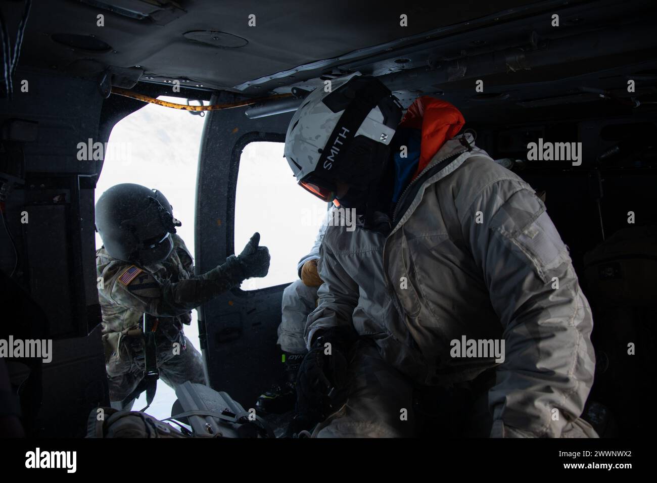 U.S. Army Green Berets with the Special Operations Mountain Warfare Training Center (SOMWTC) prepare for takeoff on a 207th Aviation Troop Command, Alaska Army National Guard, UH-60L Black Hawk helicopter from the extraction point in Anchorage, Alaska, Feb. 25, 2024. The SOMWTC are conducting glacial training in preparation for the conditions they will experience in Greenland during Arctic Edge 24 (AE24). AE24 is an annual defense exercise for the U.S. Northern Command emphasizing Joint Force operations in an extreme cold weather and high latitude environment and is designed to demonstrate Glo Stock Photo