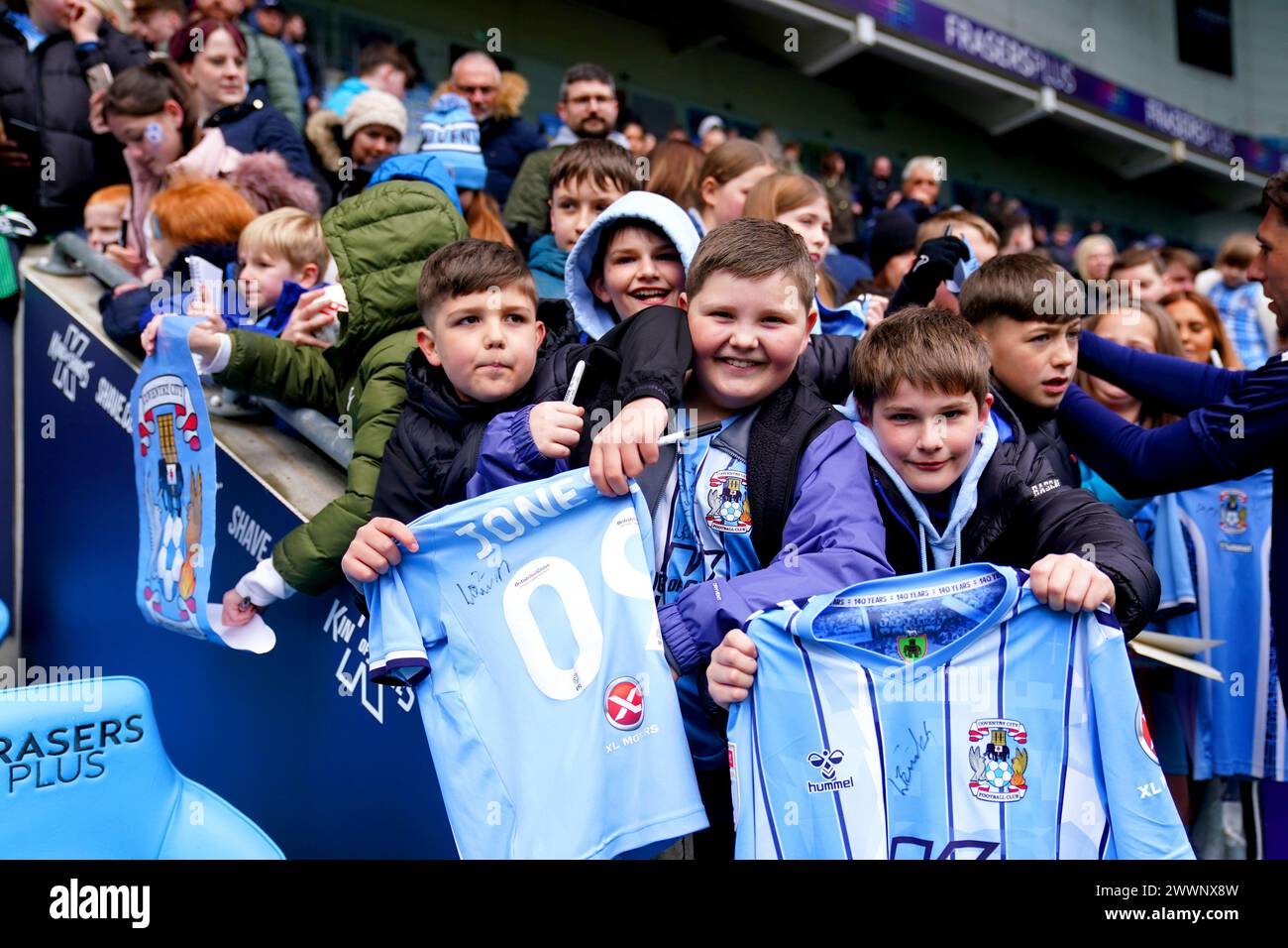 Coventry City fans hold up their signed shirts after watching a ...