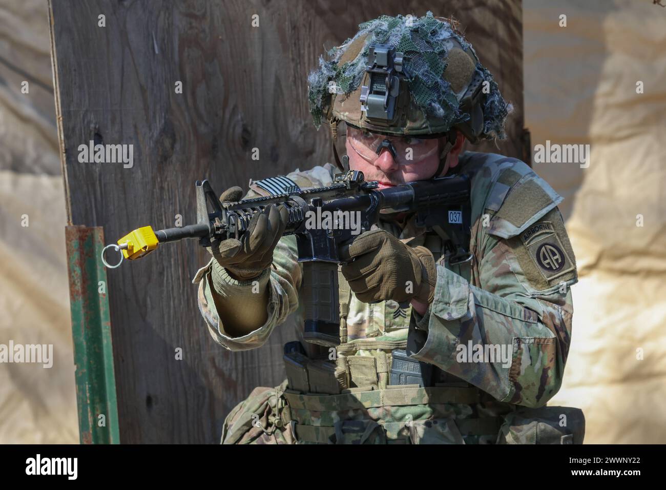 A U.S. Army soldier assigned to the 82nd Airborne Division prepares to fire an M4 carbine during the E3B competition at Fort Liberty, North Carolina, February 6, 2024. E3B refers to the combined testing for the Expert Infantryman Badge, Expert Soldier Badge and Expert Field Medical Badge.  Army Stock Photo