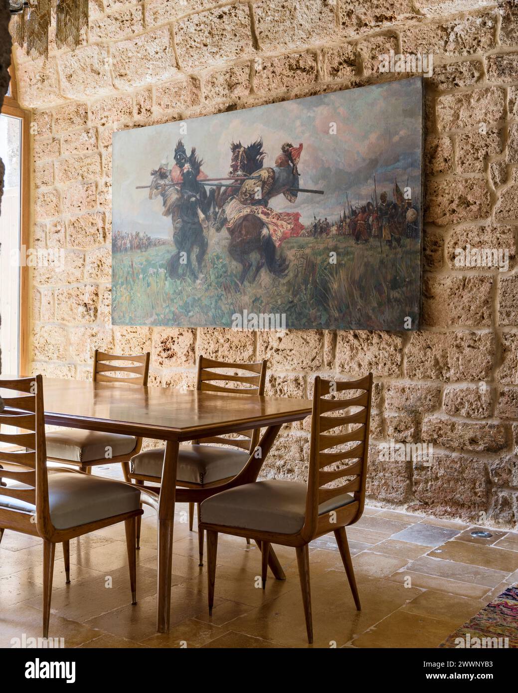 Vintage chairs at table with artwork in luxury apartment in Beirut, Lebanon. Stock Photo