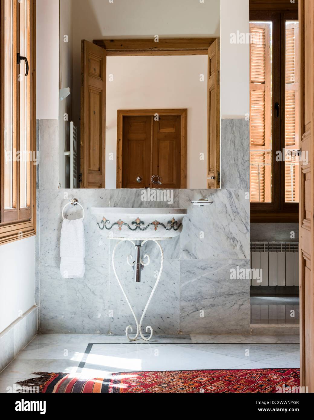 Mirror on marble wall with wash stand in luxury apartment in Beirut, Lebanon. Stock Photo