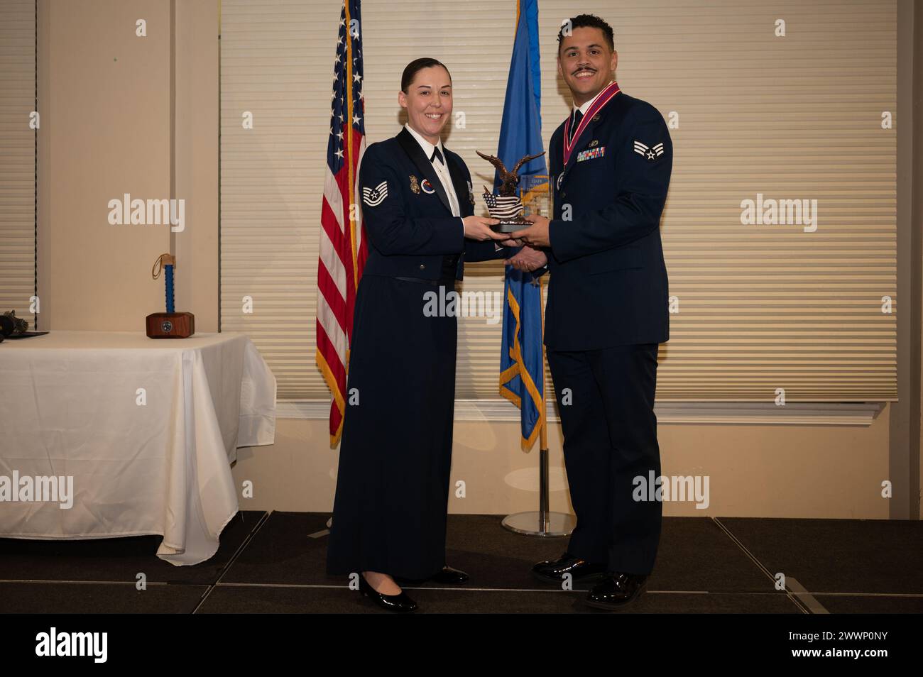 Senior Airman Daniel Andrade, 4th Civil Engineer Squadron HVAC journeyman, receives the Commandant’s Award from Tech. Sgt. Devin Pope, Airman Leadership School instructor, during the ALS class 24-B graduation ceremony at Seymour Johnson Air Force Base, North Carolina, Feb. 8, 2024. The Commandant’s Award is given to an ALS student that possesses the highest degree of character, competence and commitment.  Air Force Stock Photo