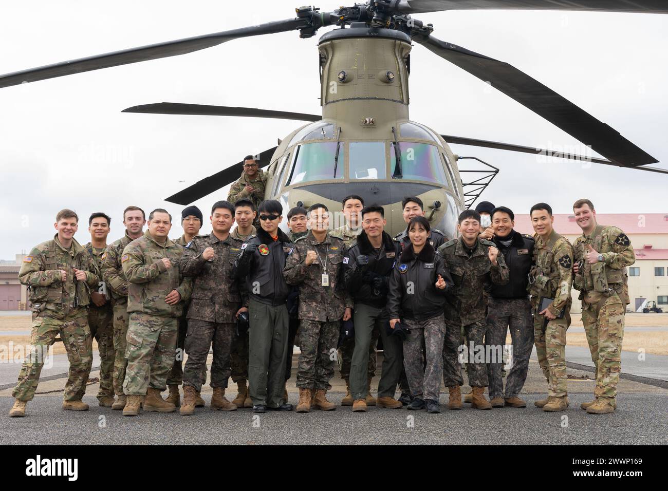 U.S. Army Chinook pilots and crew members from 3rd General Support Aviation Battalion, 2nd Combat Aviation Brigade, 2nd Infantry ROK/U.S. Combined Division, pose with 301st and 302nd Republic of Korea’s Army Aviation Battalion pilots for a group picture at Camp Humphreys, South Korea, Feb. 6, 2024. 3-2GSAB hosted ROK aviators for an aircrew exchange program that aims to bridge operational and cultural gaps between American and South Korean Chinook units.  Army Stock Photo