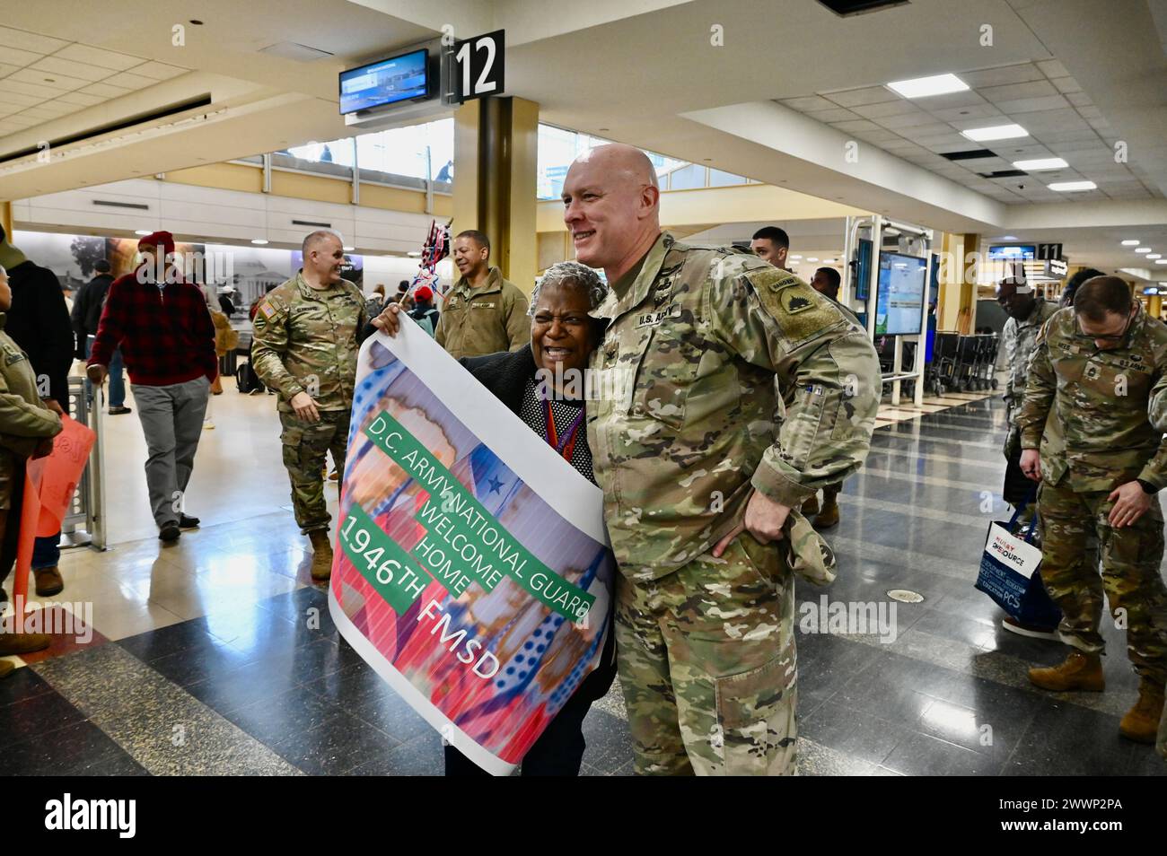 Soldiers with the 1946th Financial Management Support Detachment, District of Columbia National Guard, are greeted by family, friends, senior leadership and D.C. National Guard Family Programs reps at Ronald Reagan Washington National Airport, Feb. 16, 2024. Guard members returned from a nine-month deployment to Camp Bondsteel, Kosovo, providing financial management support to Kosovo Forces assigned to the NATO peacekeeping mission.  Air National Guard Stock Photo