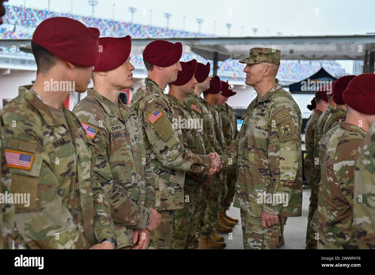 General Randy George, Chief of Staff of the Army, greets paratroopers from the U.S. Army 82nd Airborne Division 2nd Battalion, 505th Infantry Regiment during the 2024 NASCAR Daytona 500 in Daytona Beach, Fla., Sunday, Feb. 18, 2024. The Daytona 500 is a 500-mile-long NASCAR Cup Series motor race held annually and is regarded as the most important and prestigious race on the NASCAR calendar. Stock Photo
