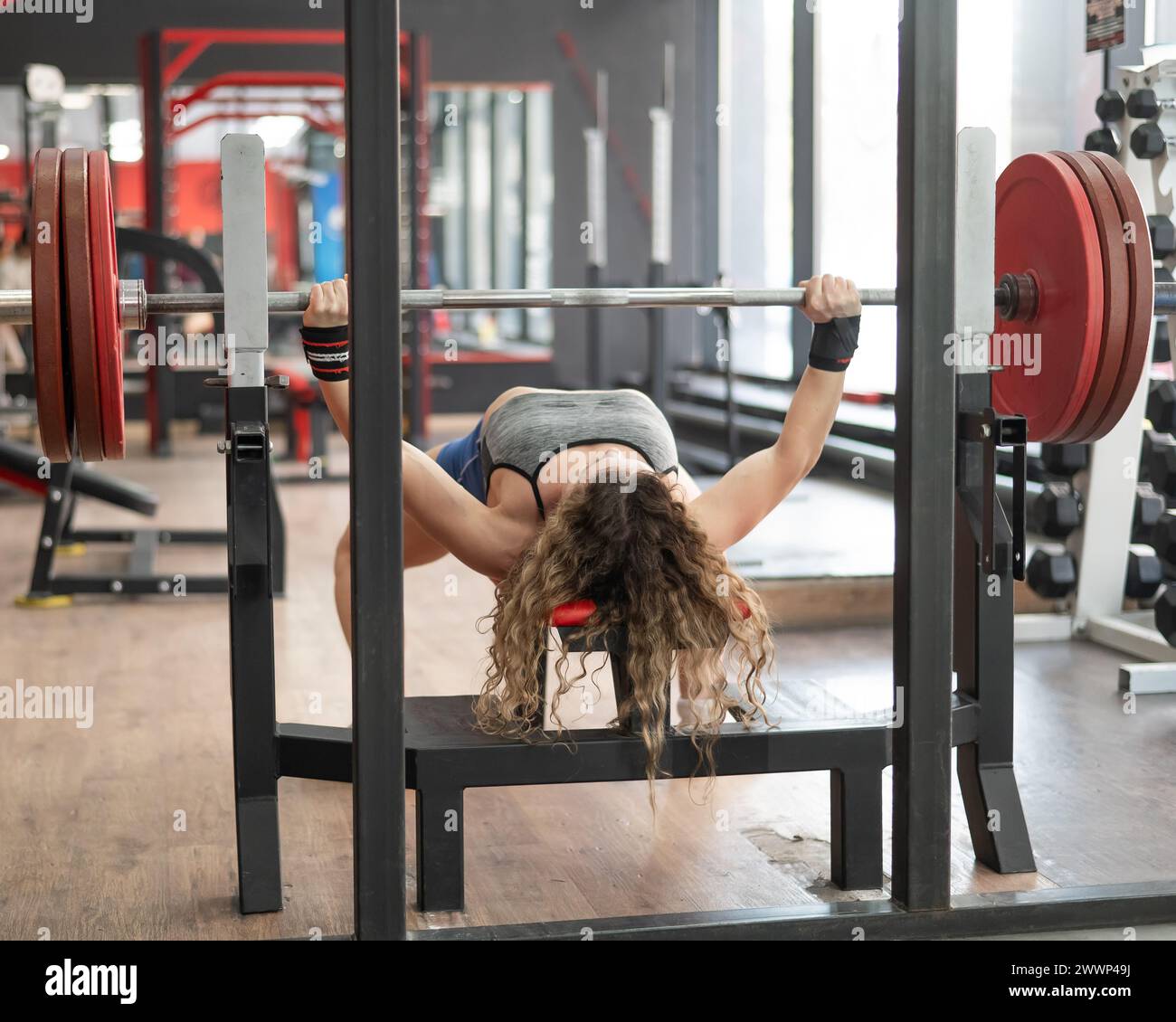 Middle aged woman doing bench press at the gym Stock Photo - Alamy