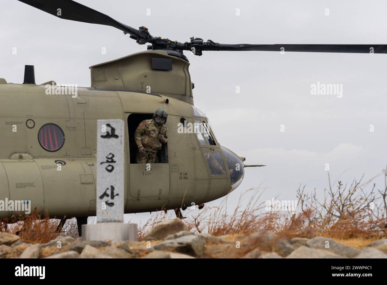 U.S. Army Cpl. Uraia Jikiono, a CH-47 Helicopter Repairer assigned to Bravo Company, 3rd General Support Aviation Battalion, 2nd Combat Aviation Brigade, 2nd Infantry ROK/U.S. Combined Division, looks out the window while conducting a flyby during the Aircrew Exchange Program on Camp Humphreys, Feb. 6, 2024. The Aircrew Exchange Program is a key initiative to bridge operational and cultural gaps between American and South Korean Chinook units.  Army Stock Photo