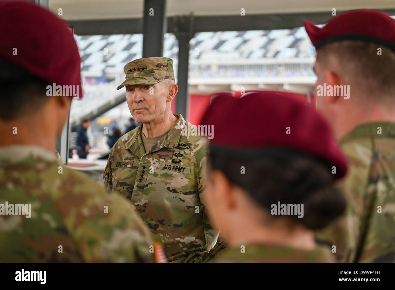 General Randy George, Chief of Staff of the Army, speaks with paratroopers from the U.S. Army 82nd Airborne Division 2nd Battalion, 505th Infantry Regiment during the 2024 NASCAR Daytona 500 in Daytona Beach, Fla., Sunday, Feb. 18, 2024. The Daytona 500 is a 500-mile-long NASCAR Cup Series motor race held annually and is regarded as the most important and prestigious race on the NASCAR calendar. Stock Photo