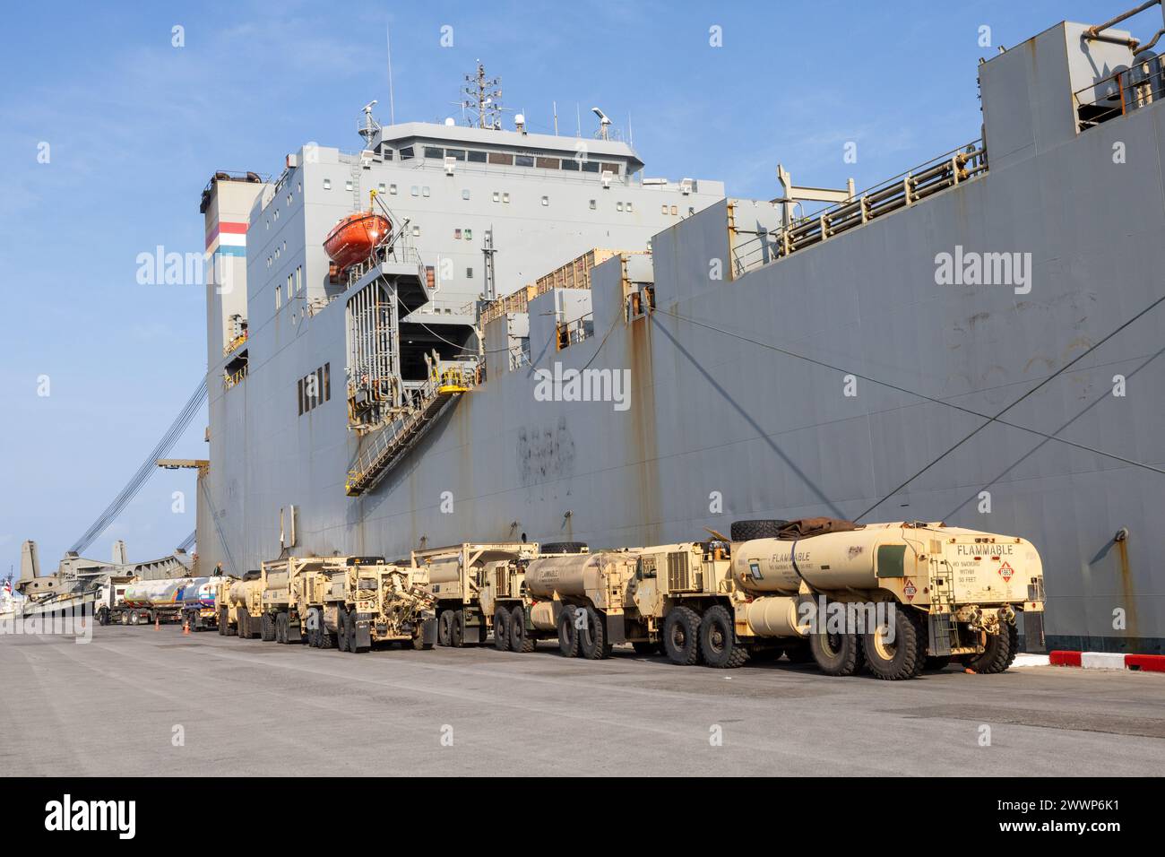 Vehicles are staged next to Military Sealift Command (MSC) chartered ship MV Cape Horn (T-AKR 5068) during an offload for exercise Cobra Gold 2024 at Sattahip, Thailand, Feb. 19. CG24 is the 43rd iteration of the Joint Cobra Gold series of exercises. CG24 emphasizes coordination on readiness, civic action, humanitarian assistance and disaster relief, and seeks to expand regional cooperation and collaboration in these vital areas. MSC directs and supports operations for approximately 140 civilian-crewed ships that replenish U.S. Navy ships at sea, conduct specialized missions, preposition comba Stock Photo