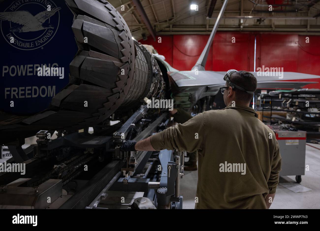 U.S. Air Force Staff Sgt. Justin Pendleton, an instructor at the F-35 maintenance training section assigned to the 388th Logistics Support Squadron, helps guide an F-135 engine into  an F-35 Lightning II jet at Hill Air Force Base, Utah, Feb. 15, 2024. Airmen completed a project that will save training time lost flying hours by creating a complete engine trainer.  Air Force Stock Photo