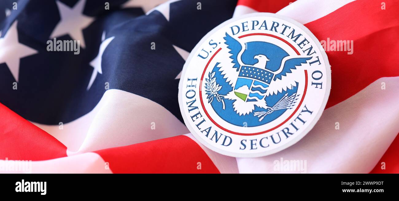 KYIV, UKRAINE - MARCH 9, 2024 US Department of Homeland Security seal on United States of America flag close up Stock Photo