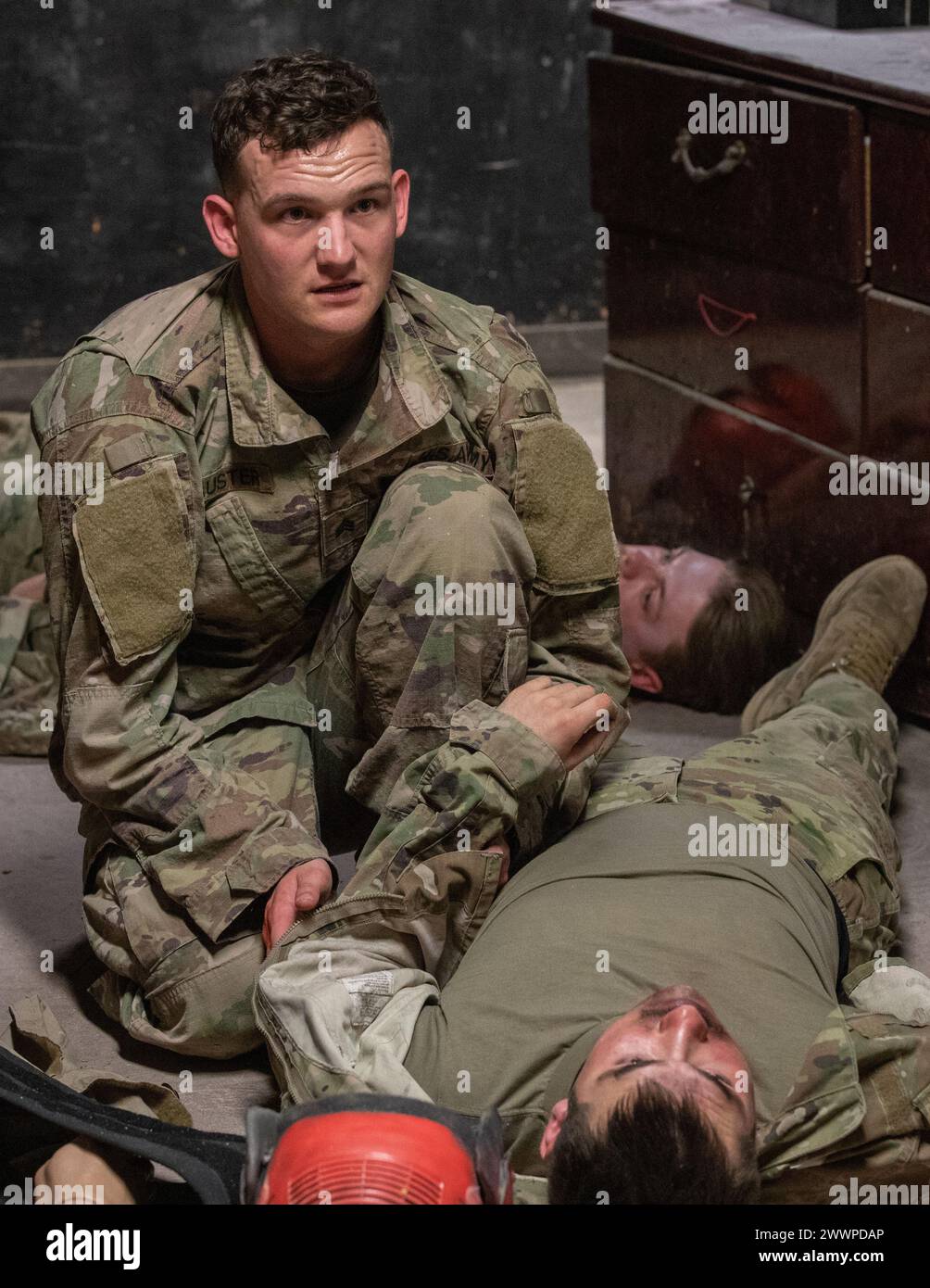 U.S. Army Sgt. Connor Lauster, assigned to C Company, 15th Brigade Support Battalion, 2nd Armored Brigade Combat Team, 1st Cavalry Division, conducts tactical field care at the Medical Simulation Training Center, on Fort Cavazos, Texas, February 22, 2024. At this stage, Lauster is checking his casualty for hemorrhage, airway obstruction, and circulatory issues.  Army Stock Photo