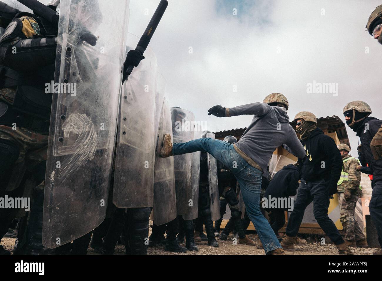 Albanian soldiers fend off simulated protestors during crowd riot ...