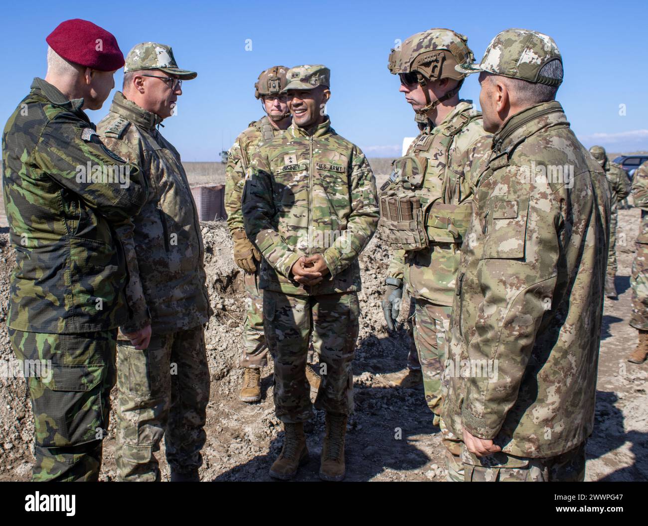 U.S. Army Capt. Patrick Gerrity, commander of Bravo Battery, 1st Battalion, 9th Field Artillery Regiment (Battleking), interacts with U.S. Army,  Türkiye Land Forces, and Czech Republic high-ranking officers, as they visit different firing positions during Exercise Dynamic Front 24 at Polatlı Training Area, Türkiye, Feb. 19, 2024. Exercise Dynamic Front 24 is a U.S. Army Europe and Africa-directed, 56th Artillery Command-led fires-centric exercise in Germany and Türkiye. Artillery Soldiers train in a joint-combined environment, focusing on fire interoperability, command, and control between mu Stock Photo