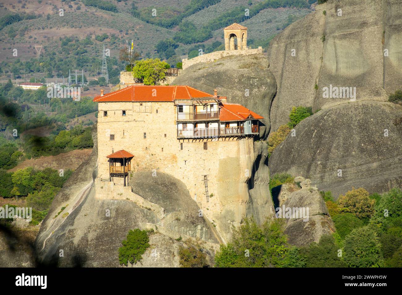 Small Monastery Greece. Sunny summer day in Kalambaka. A small monastery with red roofs ...