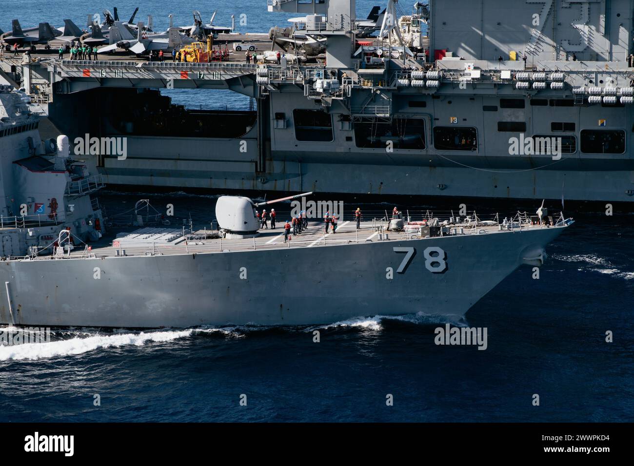 Arleigh-burke class guided-missile destroyer USS Porter (DDG 78) conducts a replenishment-at-sea with Nimitz-class aircraft carrier USS George Washington (CVN 73) while underway in the Atlantic Ocean, Feb. 26, 2024. George Washington is conducting Tailored Ships Training Availability and Final Evaluation Problem (TSTA/FEP). TSTA prepares the ship and crew for full integration into a carrier strike group through a wide range of mission critical operations.   Navy Stock Photo