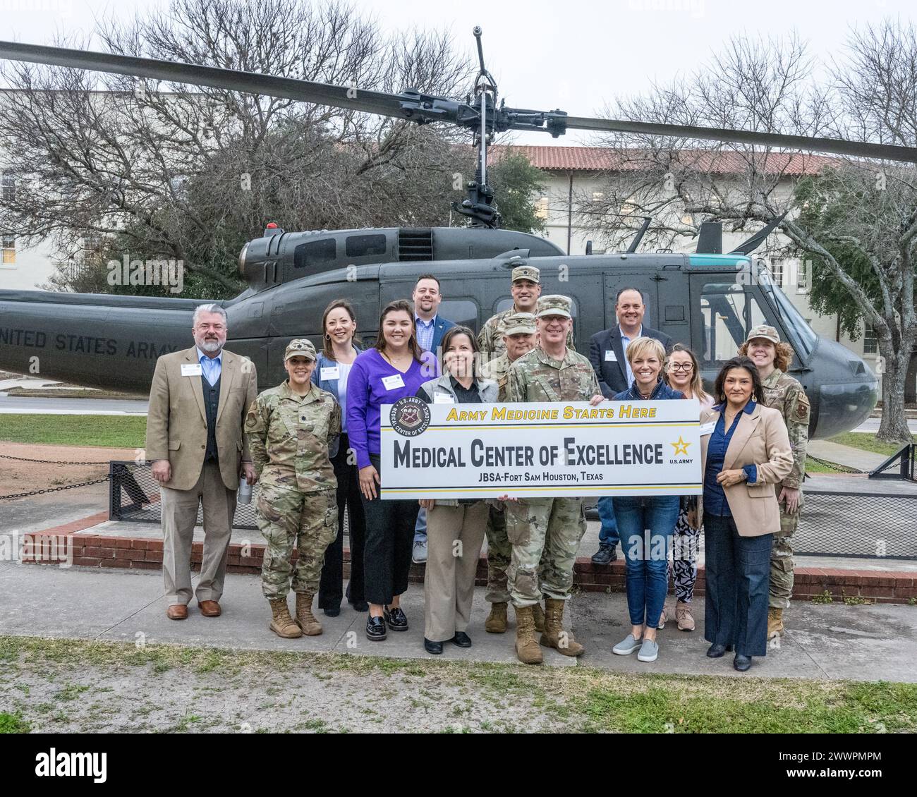 Honorary commanders and their military counterparts pose in front of U