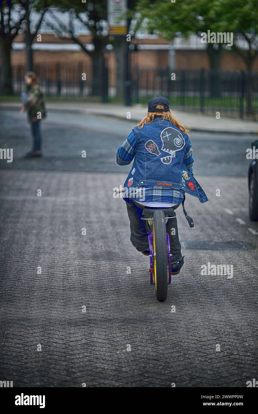 Rare view of young male riding a Low rider custom bicycle Stock Photo