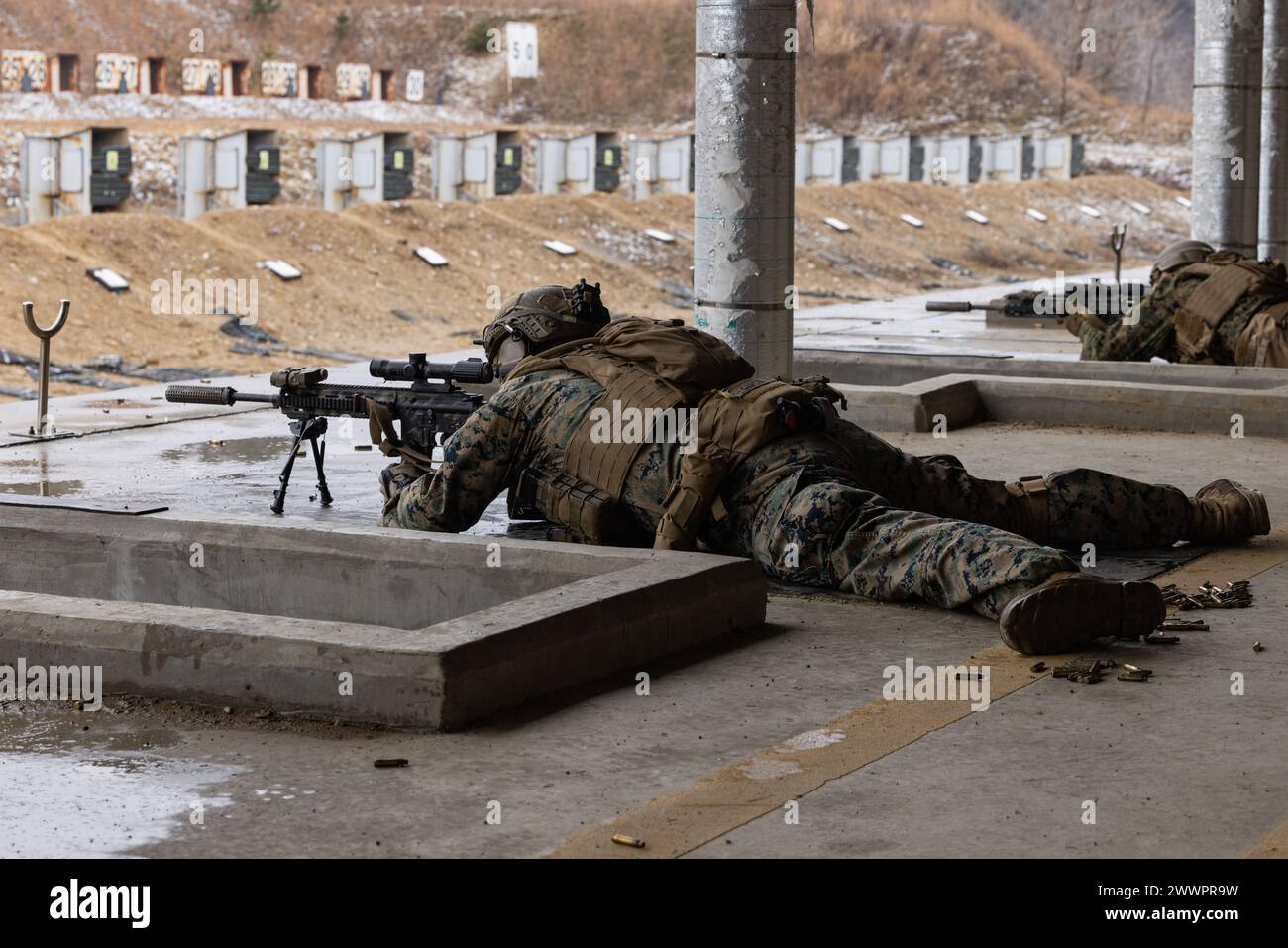 U.S. Marine Corps Lance Cpl. Luis Garcia fires an M27 Infantry ...