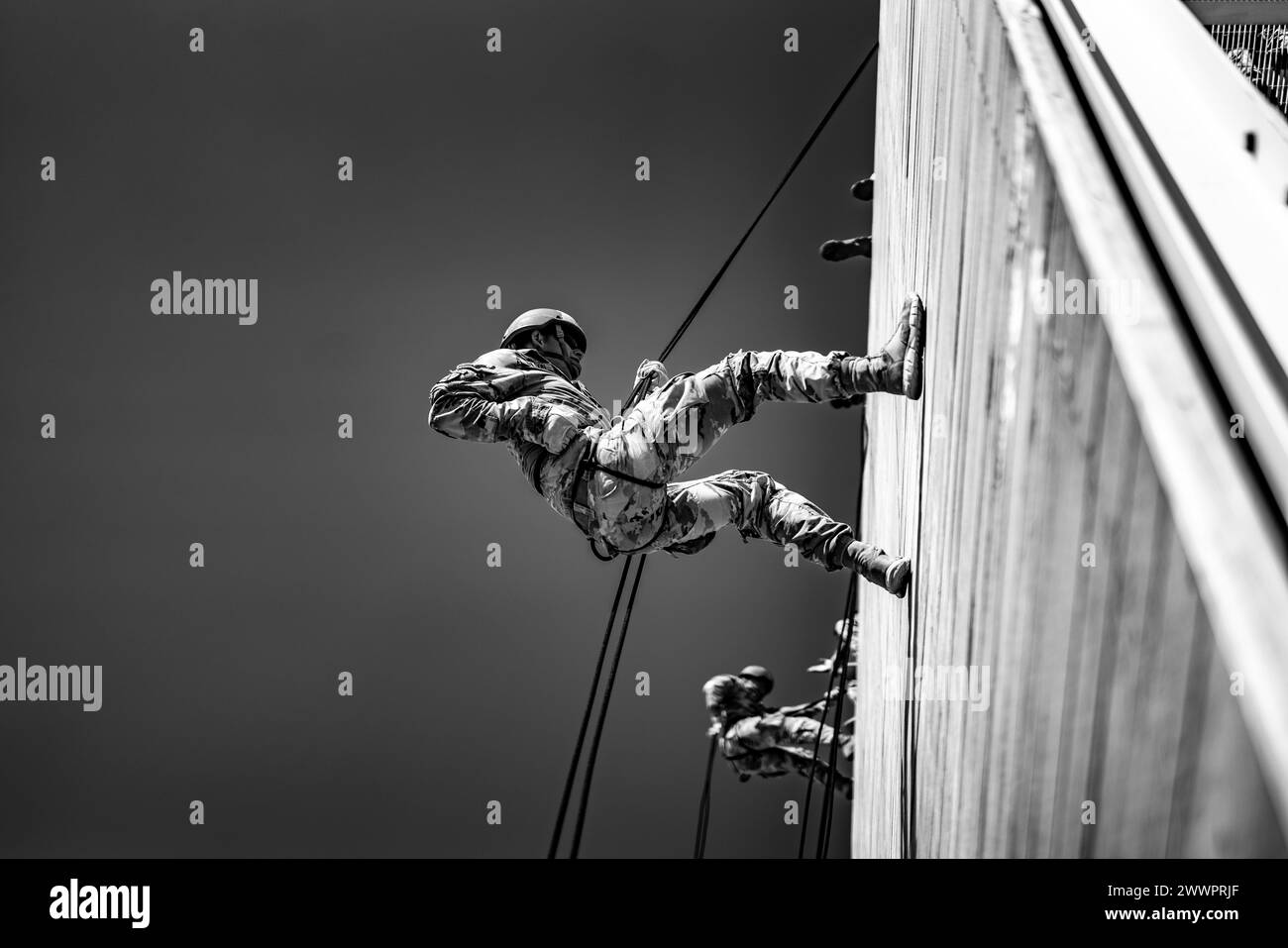 Air Assault candidates rappel off the rappel towers on Camp Buehring, Kuwait, February 20, 2024. After successfully rappeling from the towers, candidates will rappel out of rotary wing aircraft.  Army Stock Photo