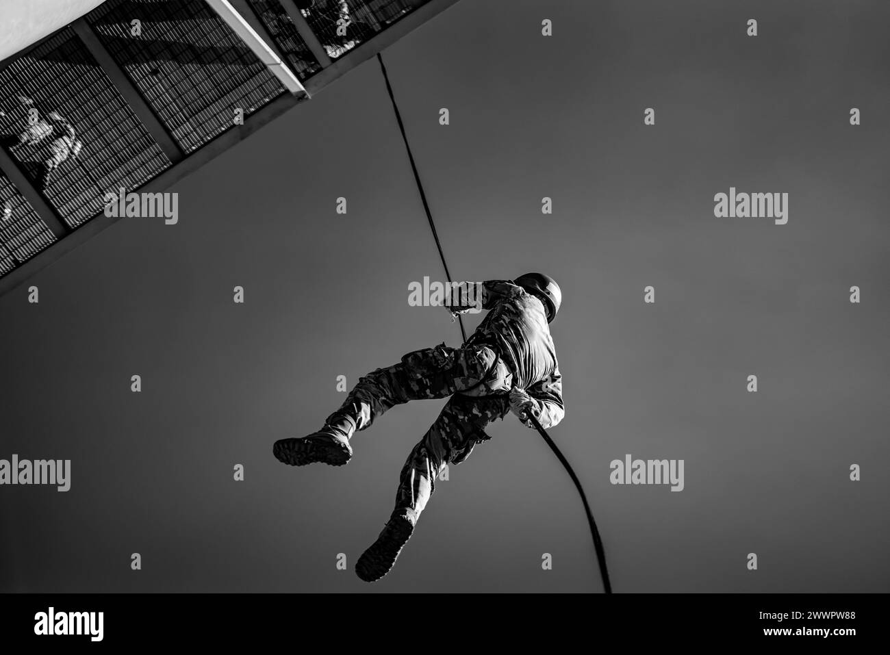 Air Assault candidates rappel off the rappel towers on Camp Buehring, Kuwait, February 20, 2024. After successfully rappeling from the towers, candidates will rappel out of rotary wing aircraft.  Army Stock Photo