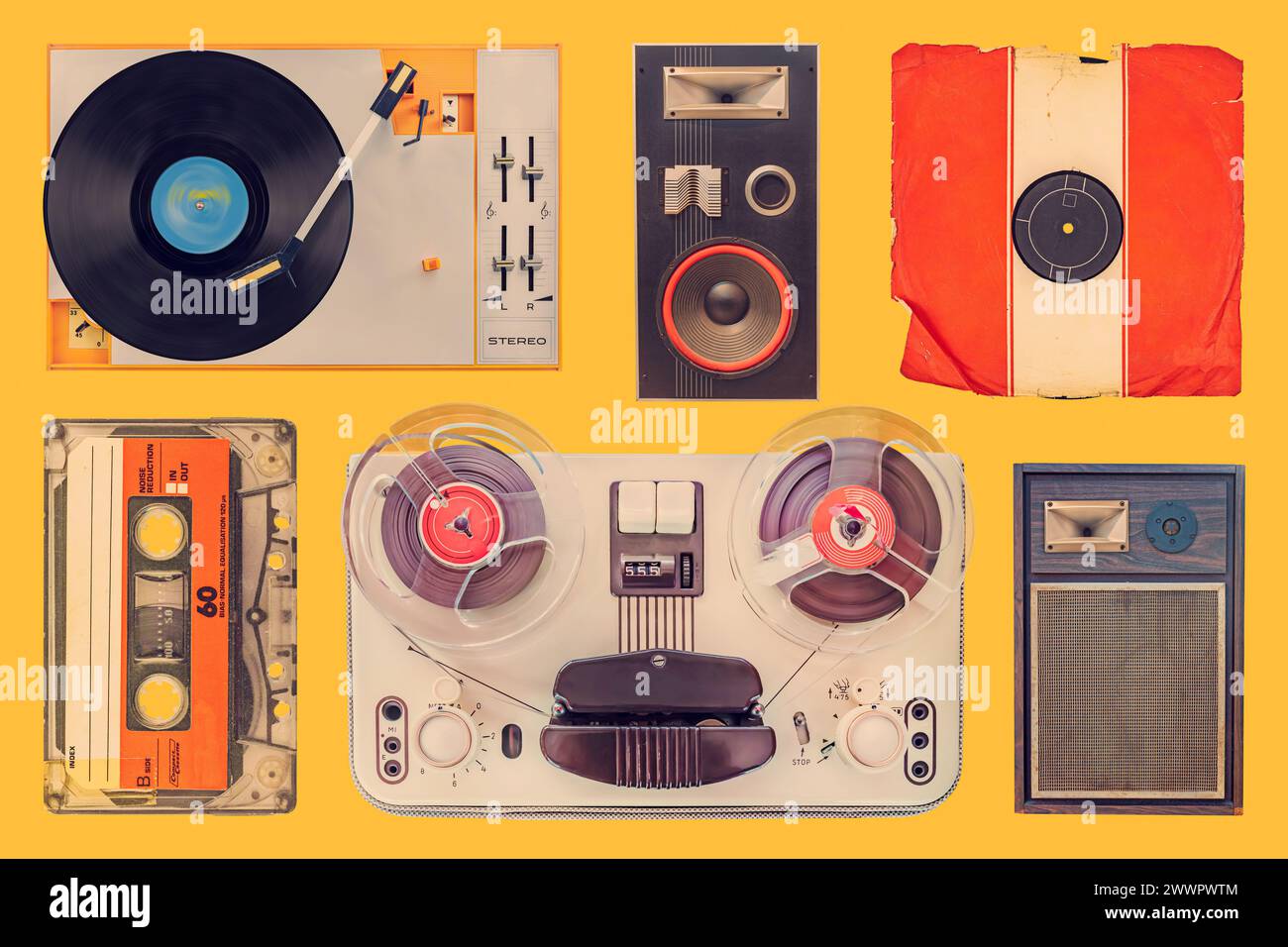 Collection of a vintage turntable, speakers, record, compact cassette and tape recorder on an orange background Stock Photo