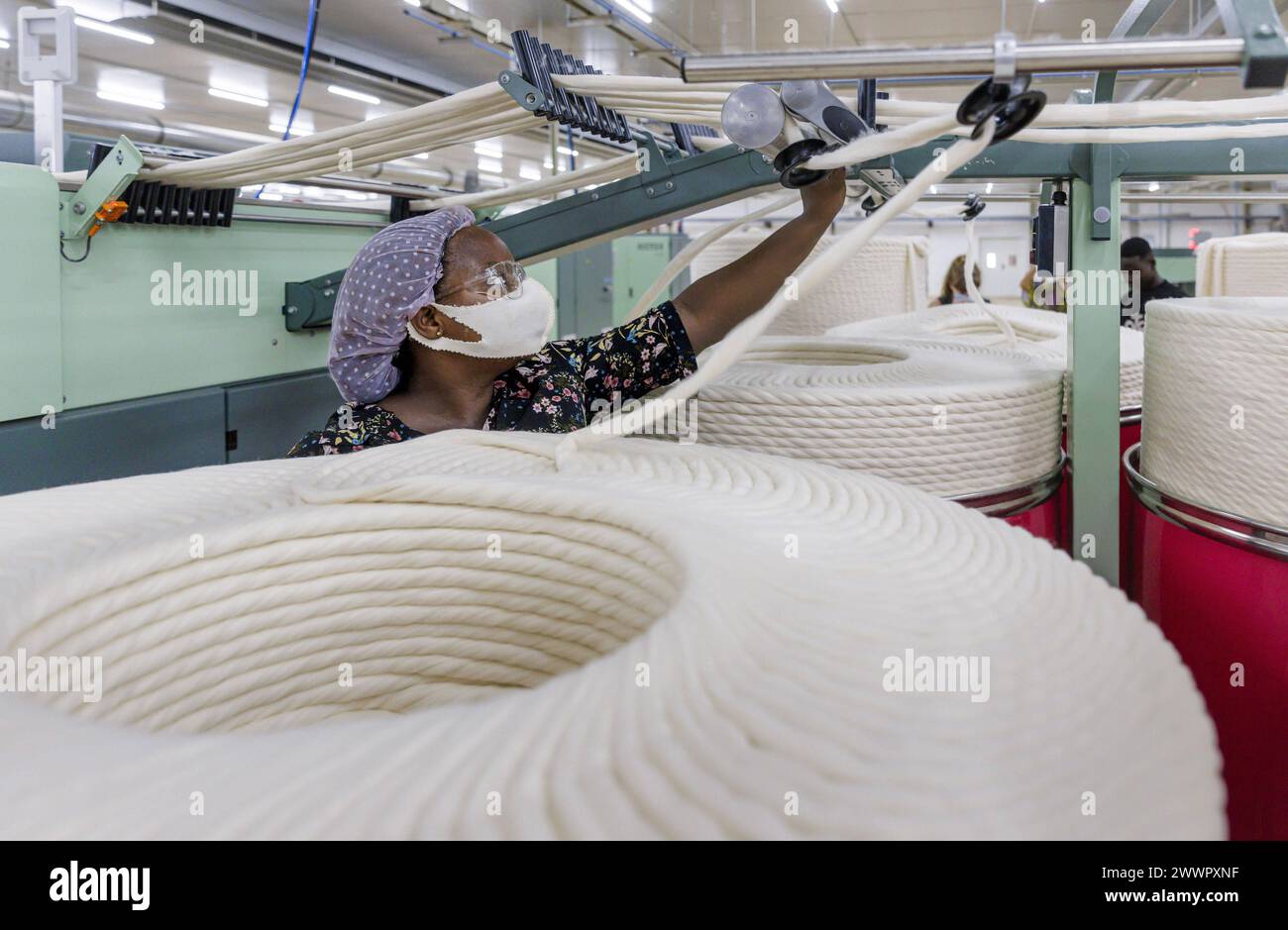 BENIN TEXTILE CORPORATION BENIN, Kaemmmaschine, die ein Kaemmband zum verspinnen von Garnen produziert. in einer Textilfabrik in der Naehe von Cotonou in Benin, Glo-Djigbe, 07.03.2024. Glo-Djigbe Benin *** BENIN TEXTILE CORPORATION BENIN, Camming machine producing a camming band for spinning yarns in a textile factory near Cotonou in Benin, Glo Djigbe, 07 03 2024 Glo Djigbe Benin Copyright: xUtexGrabowskyxphotothek.dex Stock Photo