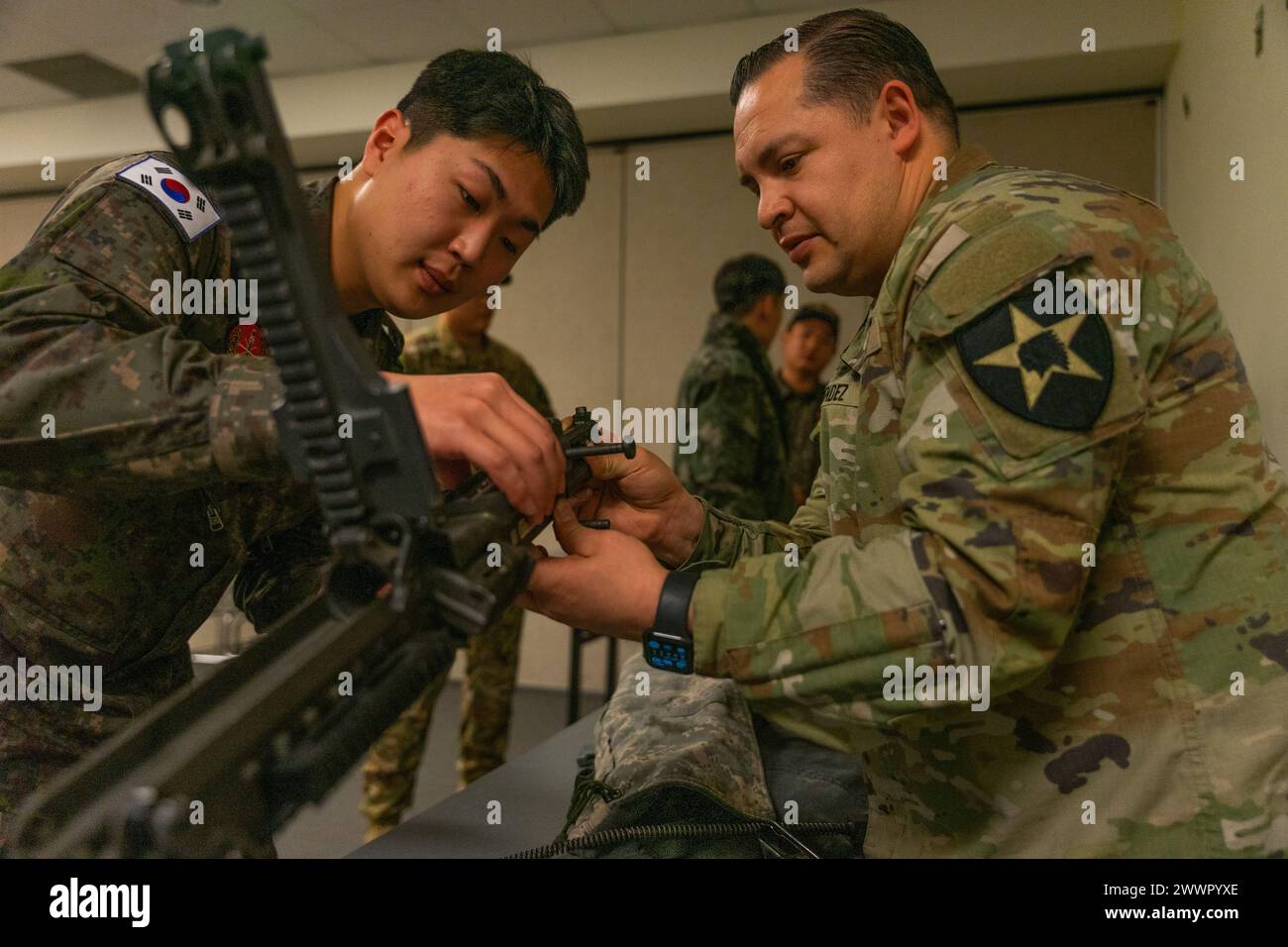 U.S. Army Staff Sgt. Juan Mendez, a CH-47 Helicopter Repairer assigned to Bravo Company, 3rd General Support Aviation Battalion, 2nd Combat Aviation Brigade, 2nd Infantry ROK/U.S Combined Division, performs a weapons functions check for a ROK pilot on Camp Humphreys, South Korea, Feb. 7, 2024. During the aircrew exchange program, ROK aviators got a comprehensive demonstration of weapons that U.S. pilots and crew members must certify with.  Army Stock Photo