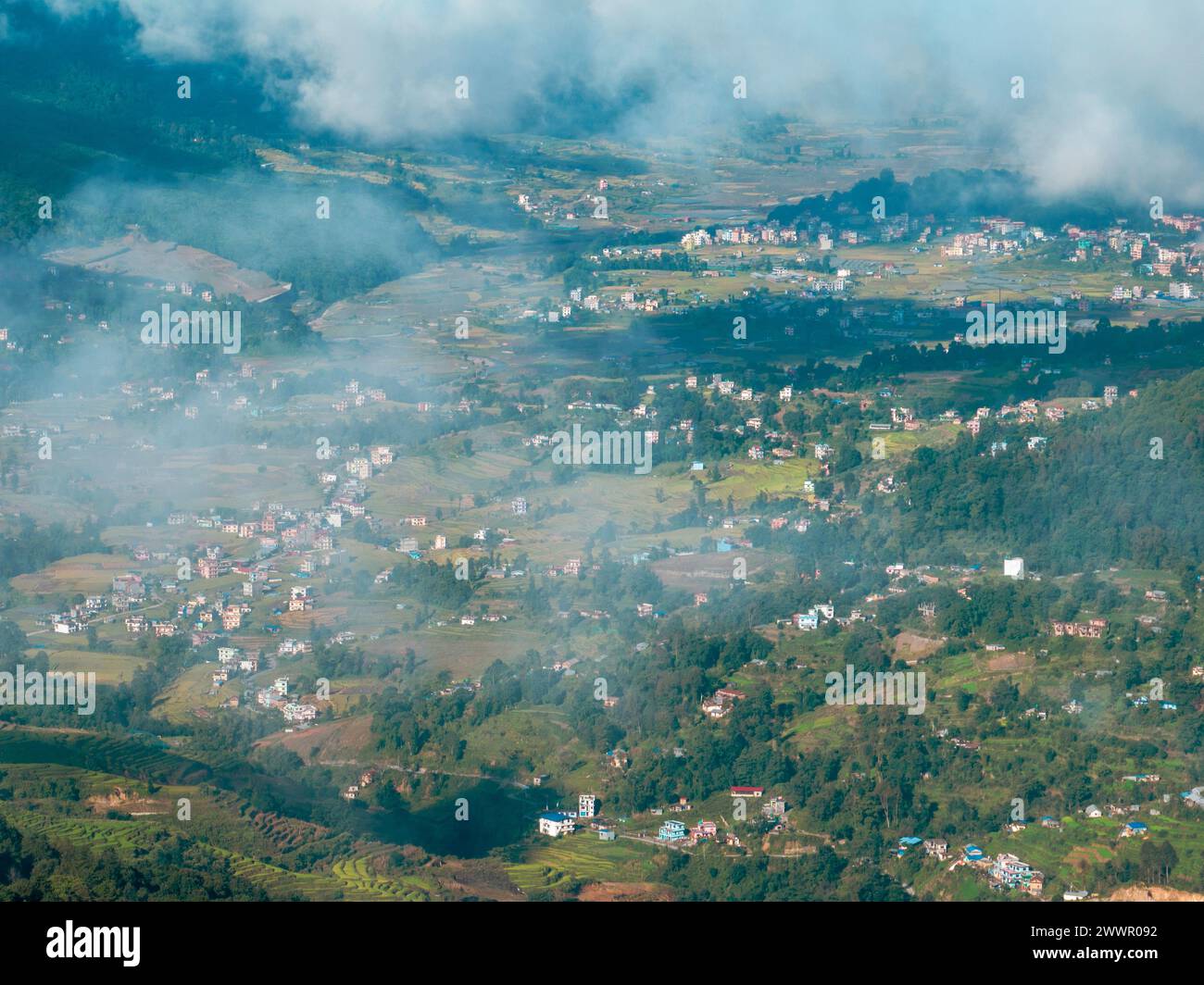Aerial view of some Nepalese villages surrounded by nature and rice fields in the valleys at the foot of the Himalayan mountain, Nagarkot, Nepal Stock Photo