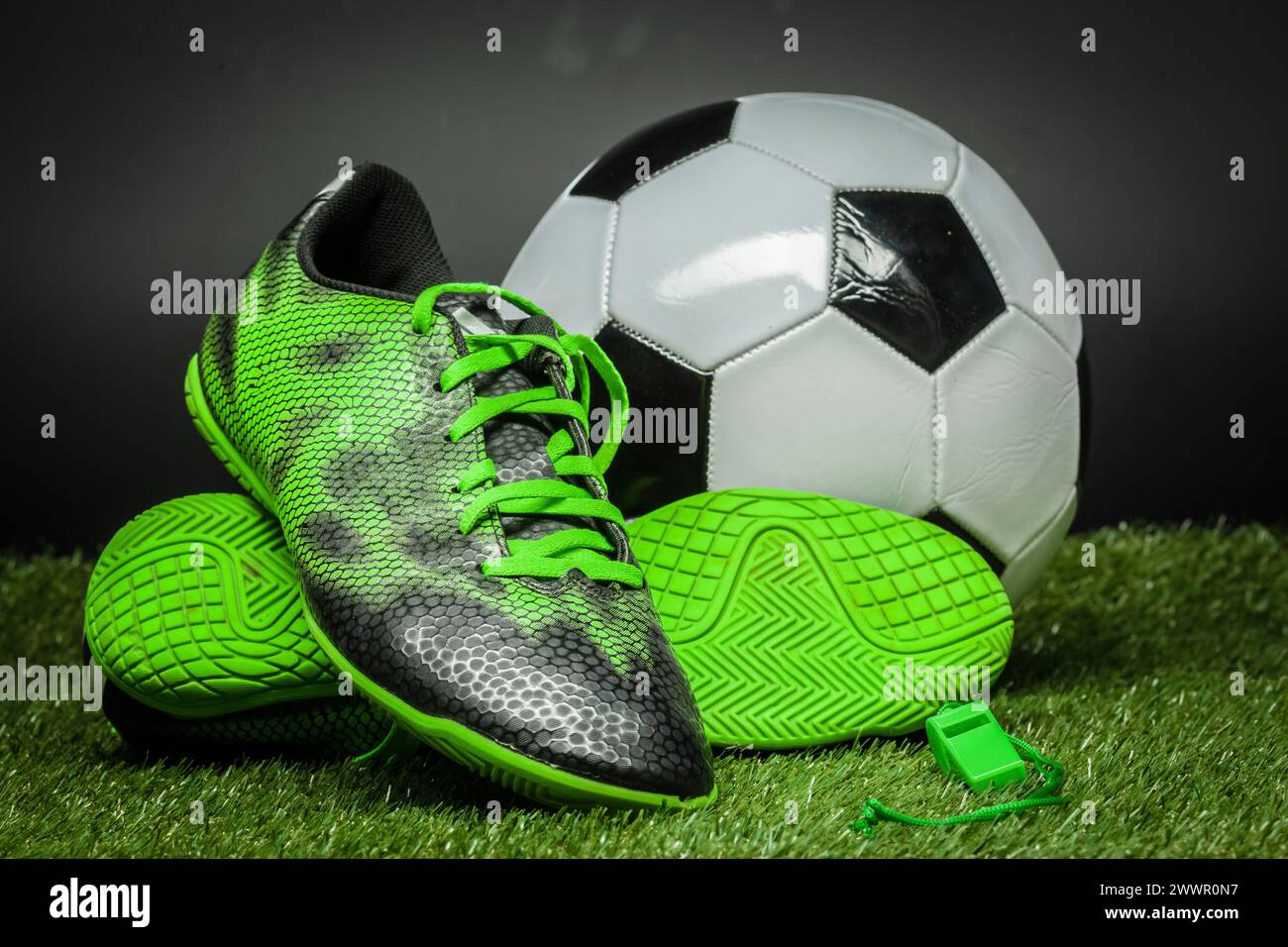 soccer ball and cleats on the football field Stock Photo - Alamy